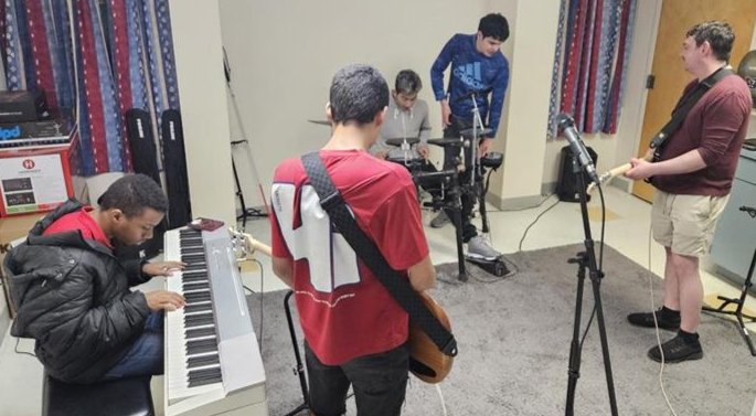 MacWilliams boys playing instruments in their band room