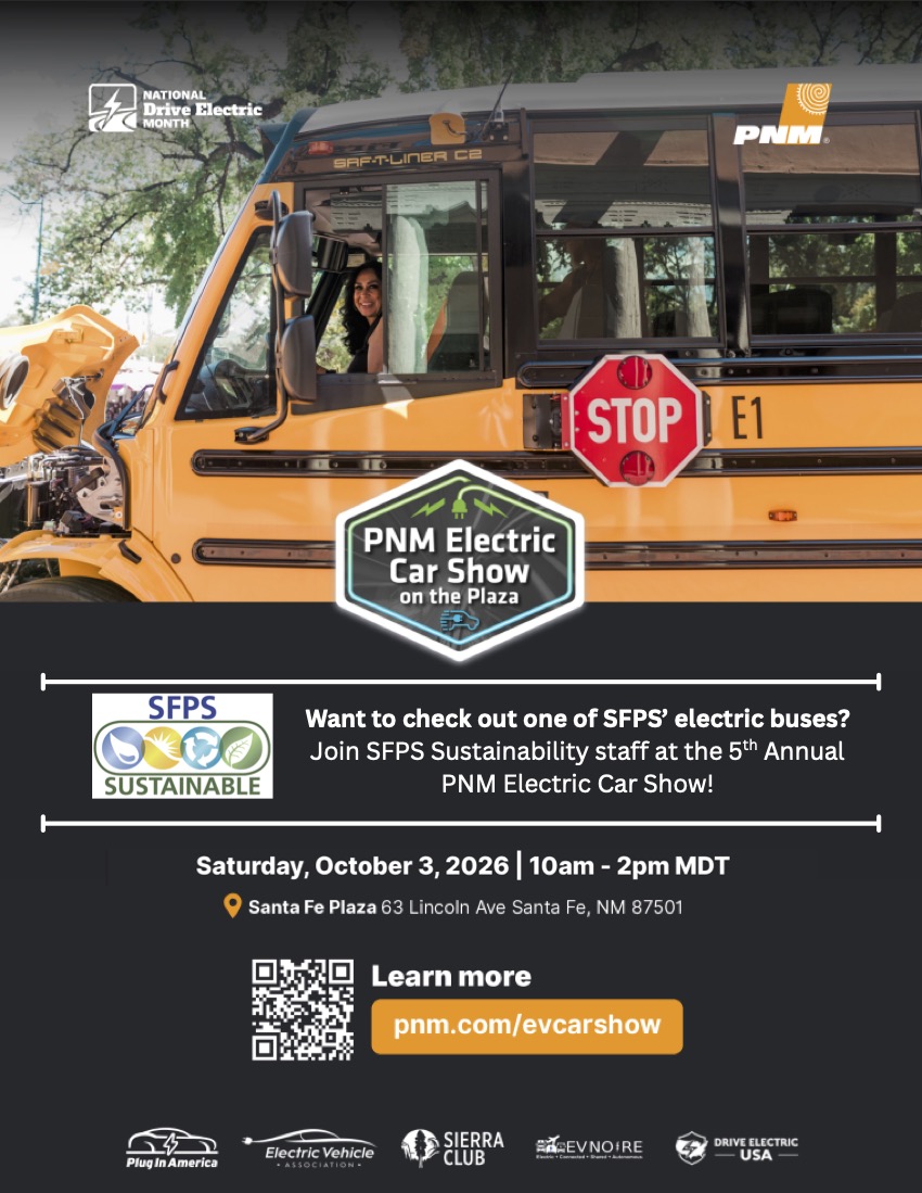 A yellow electric bus with a driver, advertisement text, and logos. Background with trees.
