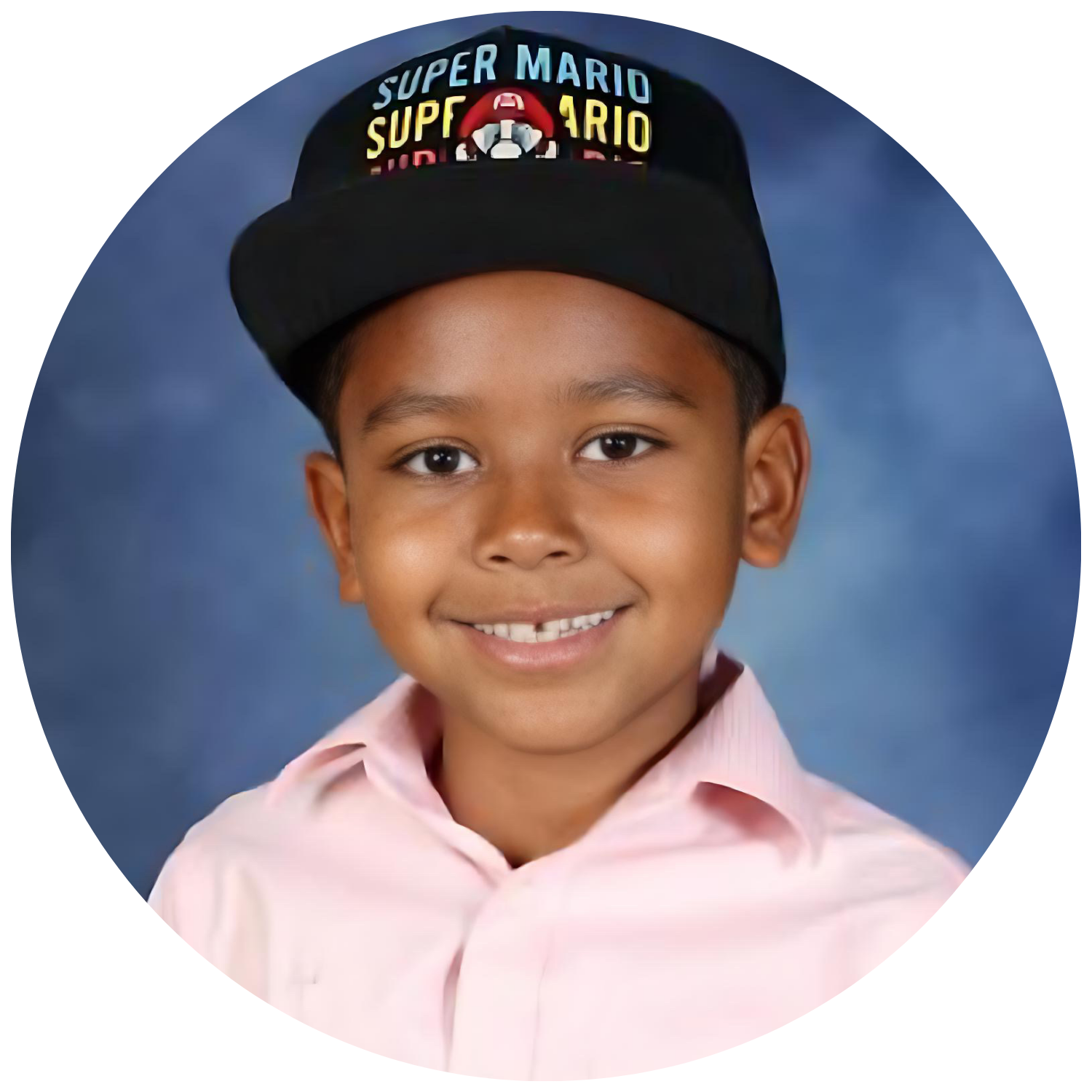 A boy in a pink shirt and black hat with 