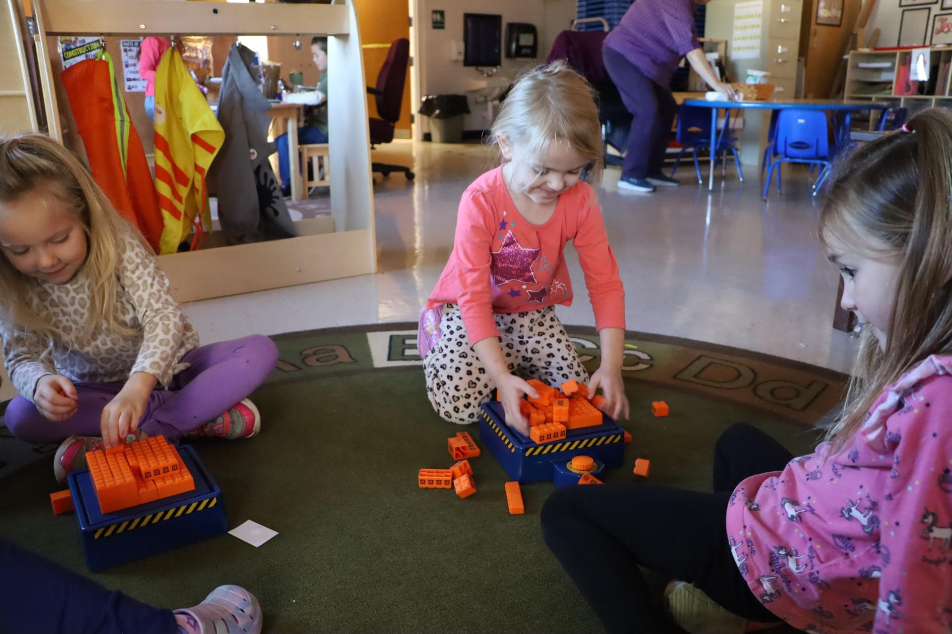 little girl playing with construction blocks