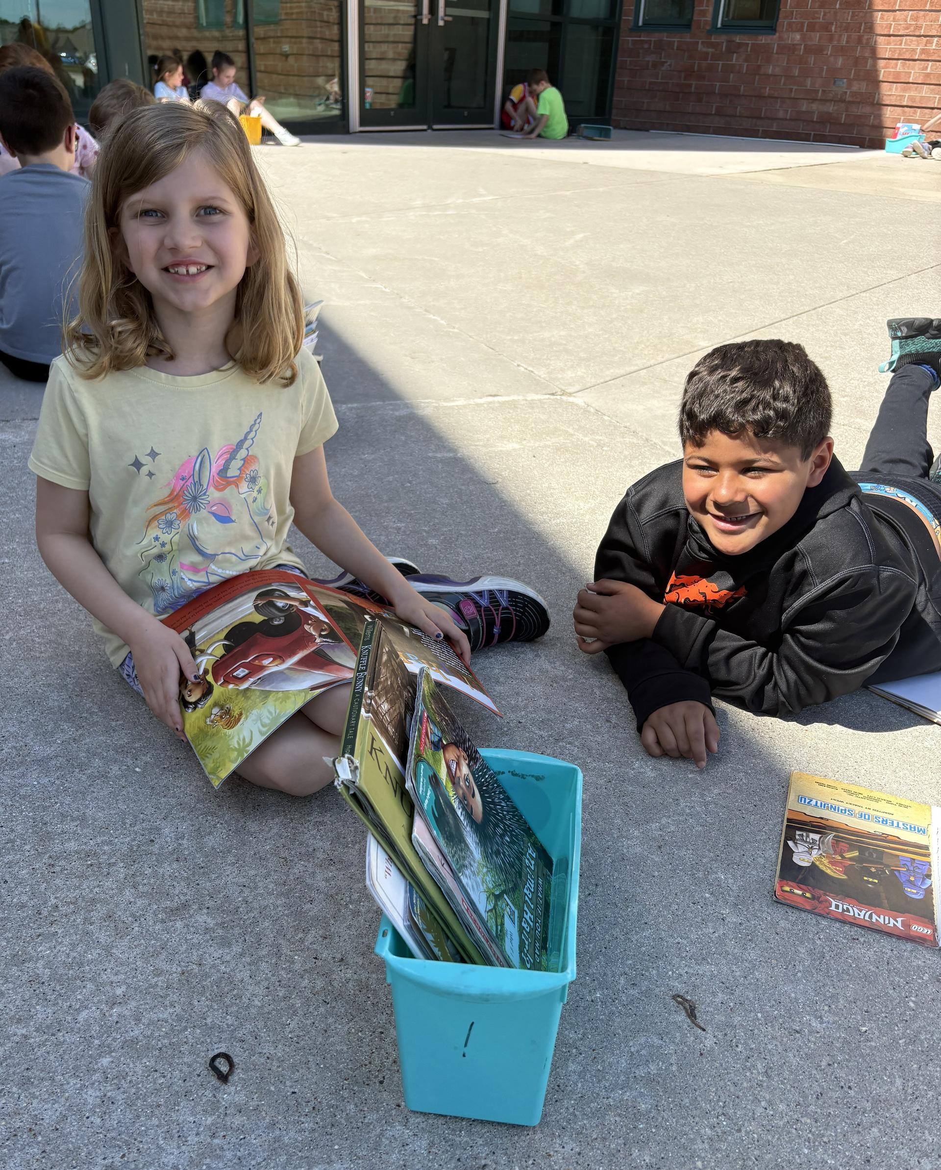 Elementary School students reading outside