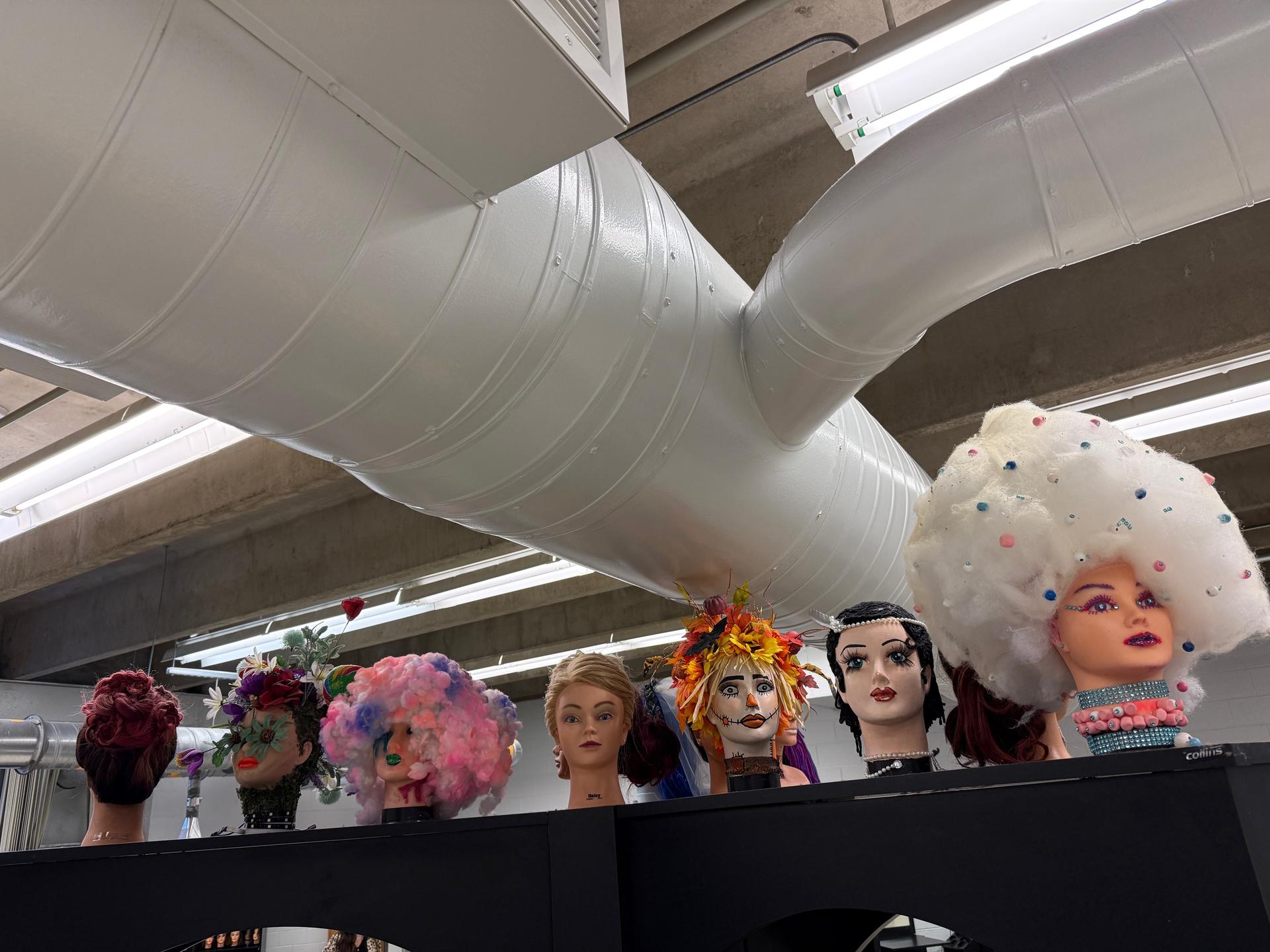 A favorite hands-on activity among students is the “Anything But Hair” project, where they use mannequin heads to showcase creativity in unique and artistic ways.