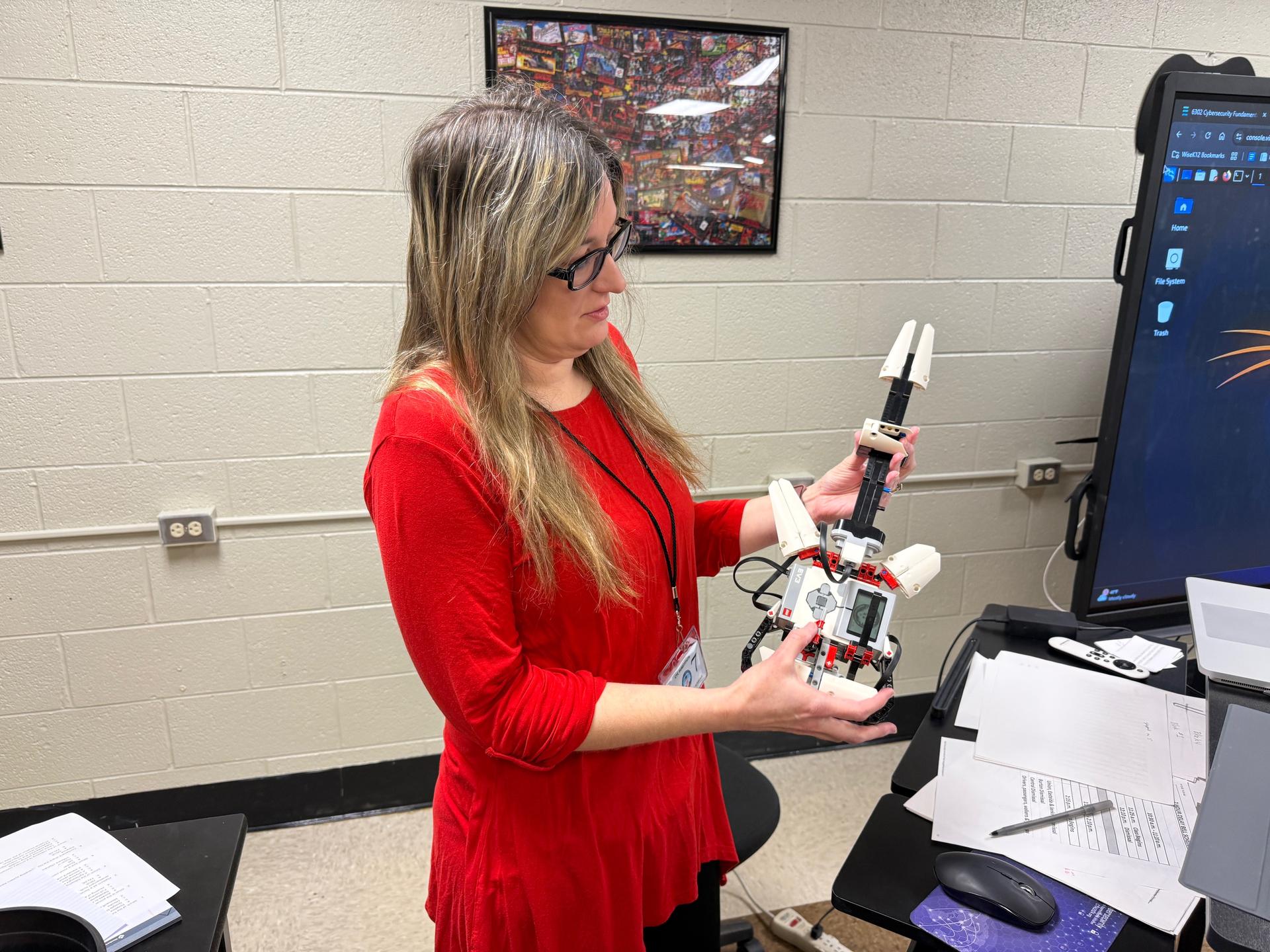 Mrs. Lawson holds a Lego robotic guitar a student programmed