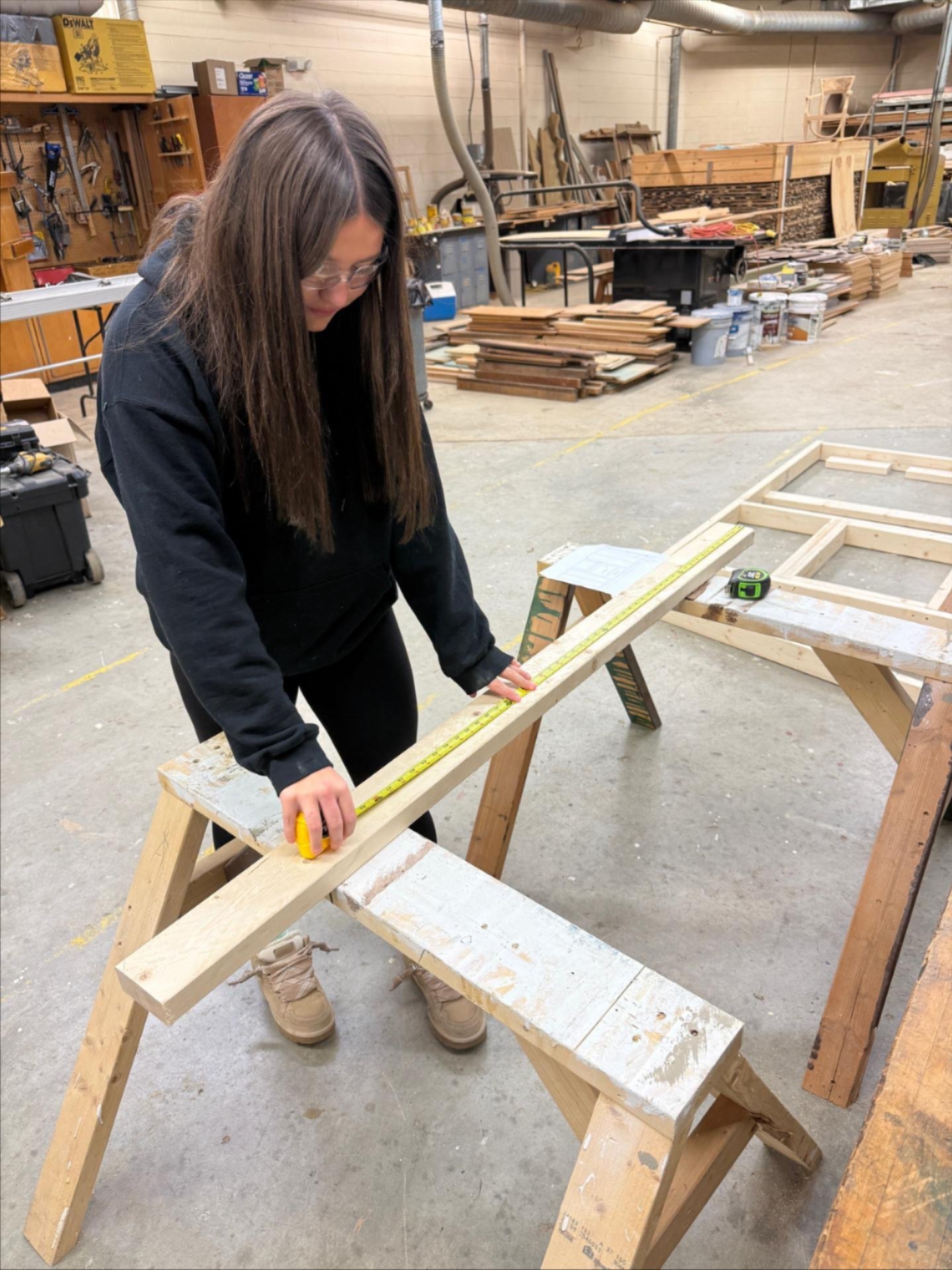 A female student cuts a board