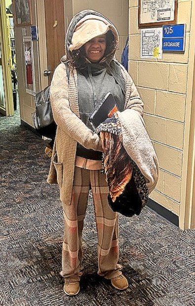 Gabby dressed in many warm layers, smiling giddily