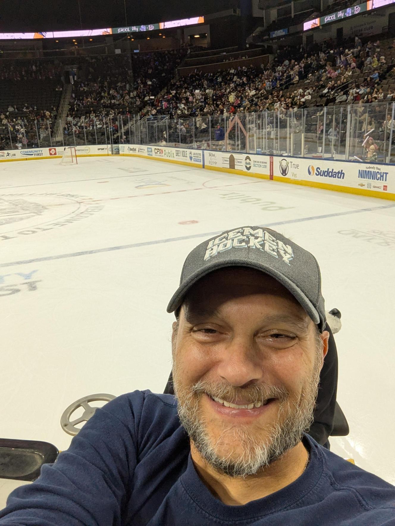 Mr. Cosgrove taking a selfie on the Zamboni; he has a wide smile and bright eyes