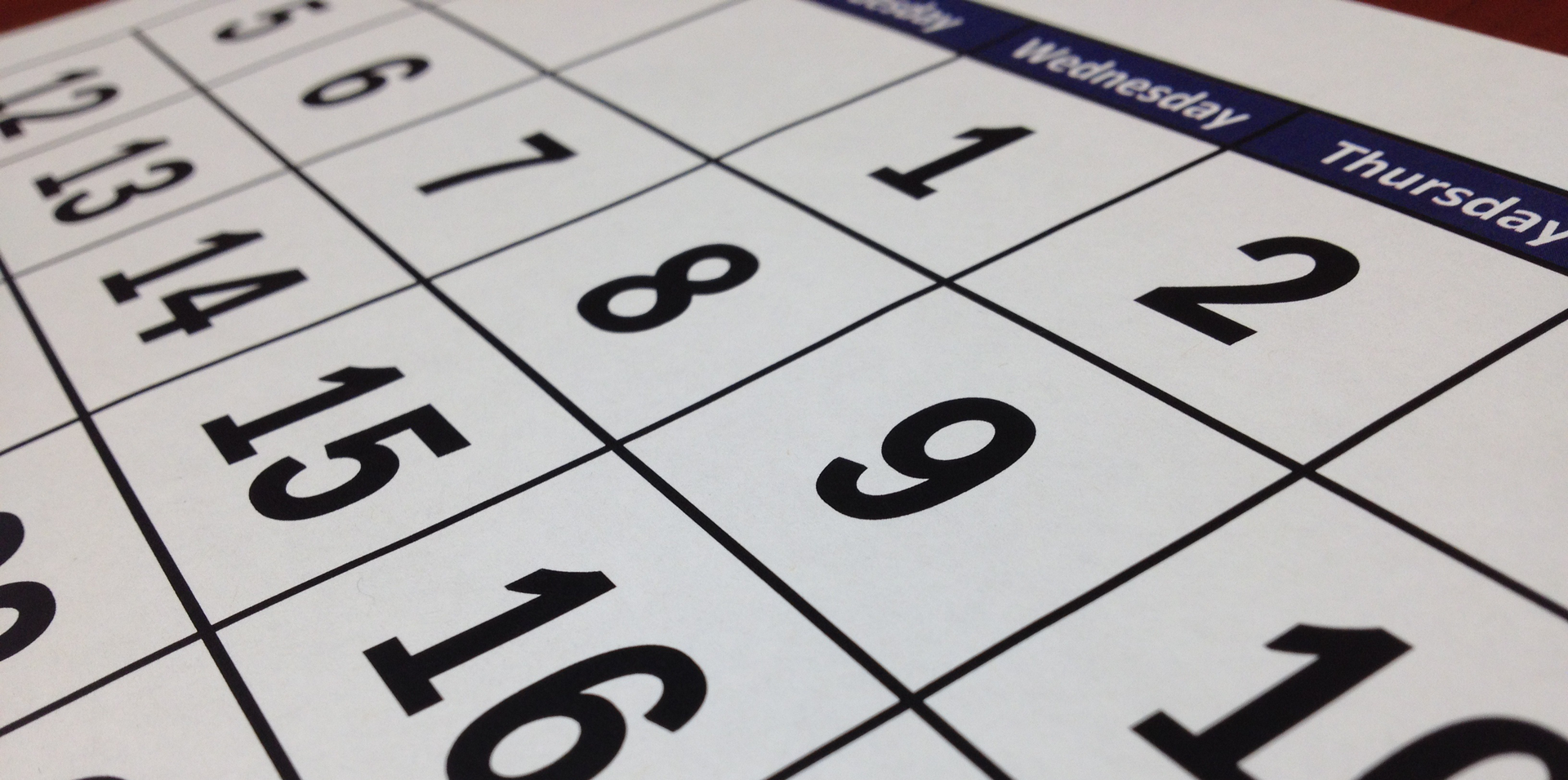 A calendar grid at a zoomed-in angle shows numbered dates on a calendar