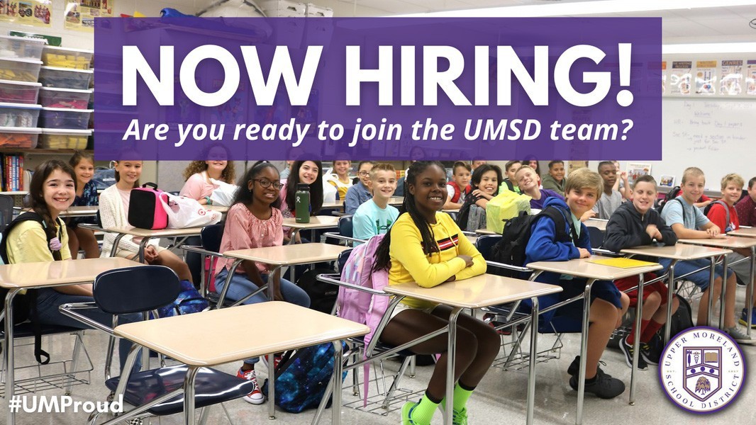 Picture of students smile in a classroom reading 