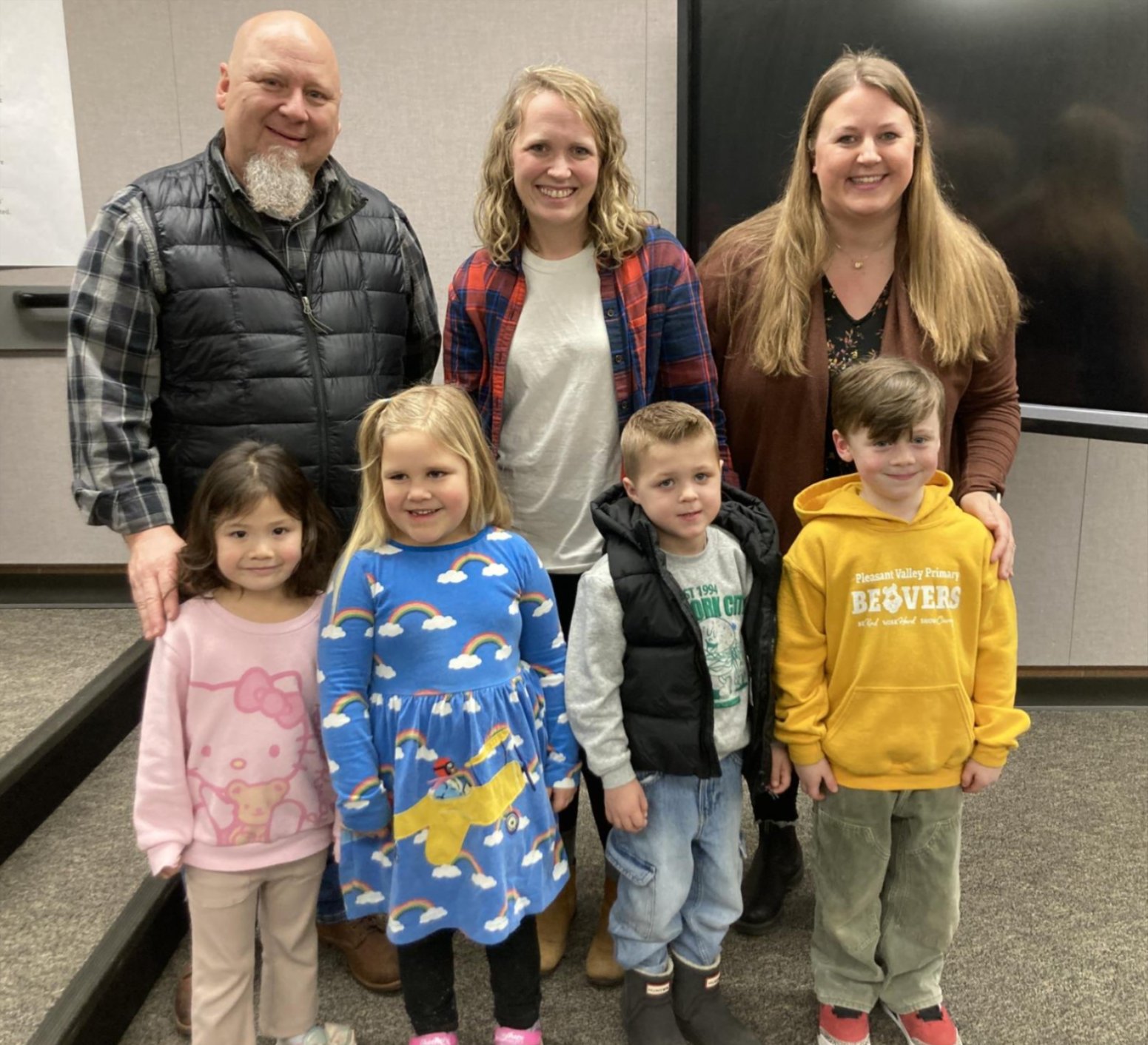 Students and teachers after presenting during a school board meeting