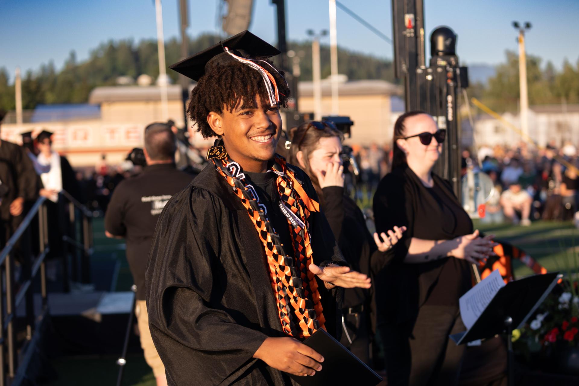 A Battle Ground High School graduate smiles after receiving a diploma