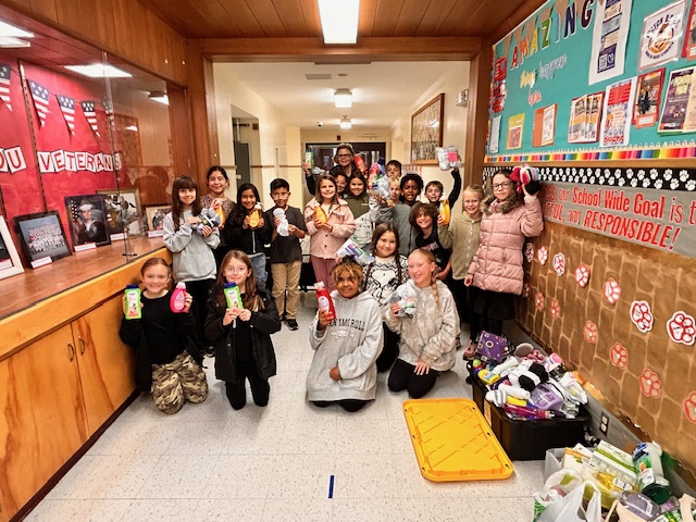 Student leaders from Glenwood Heights Primary display the donated items that they collected