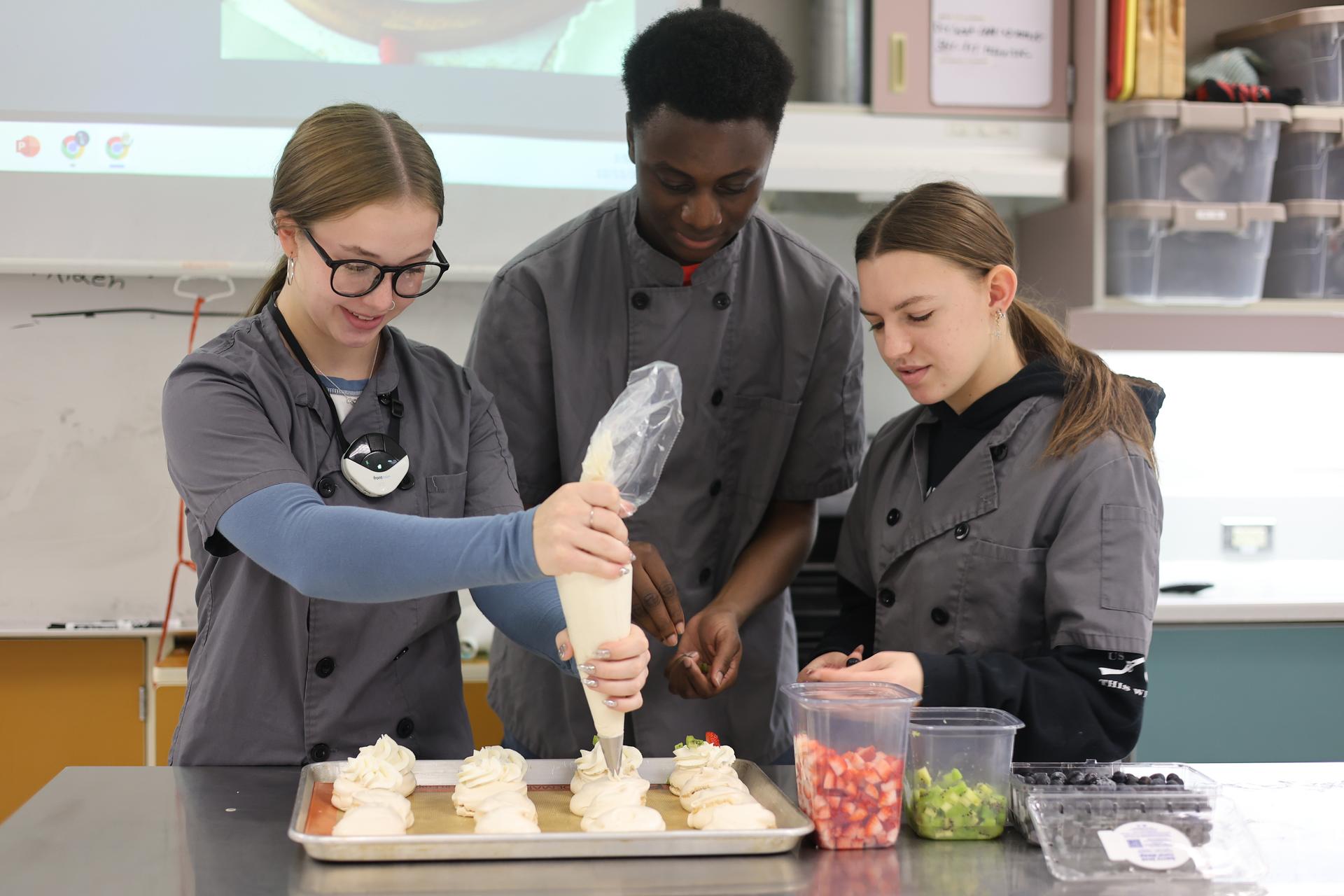 Advanced culinary arts students working on creating pavolvas.
