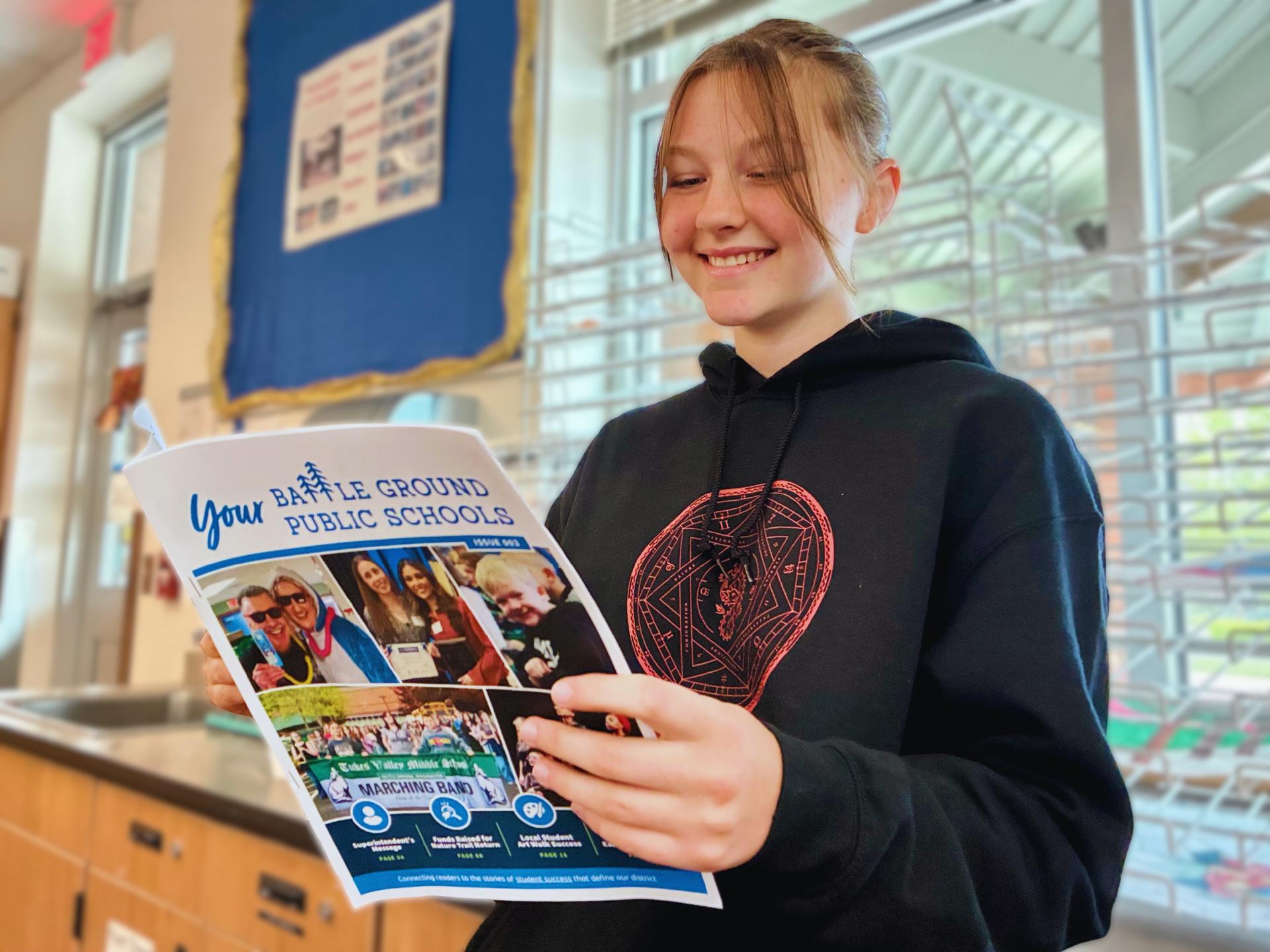 A student reads the latest issue of Your Battle Ground Public Schools