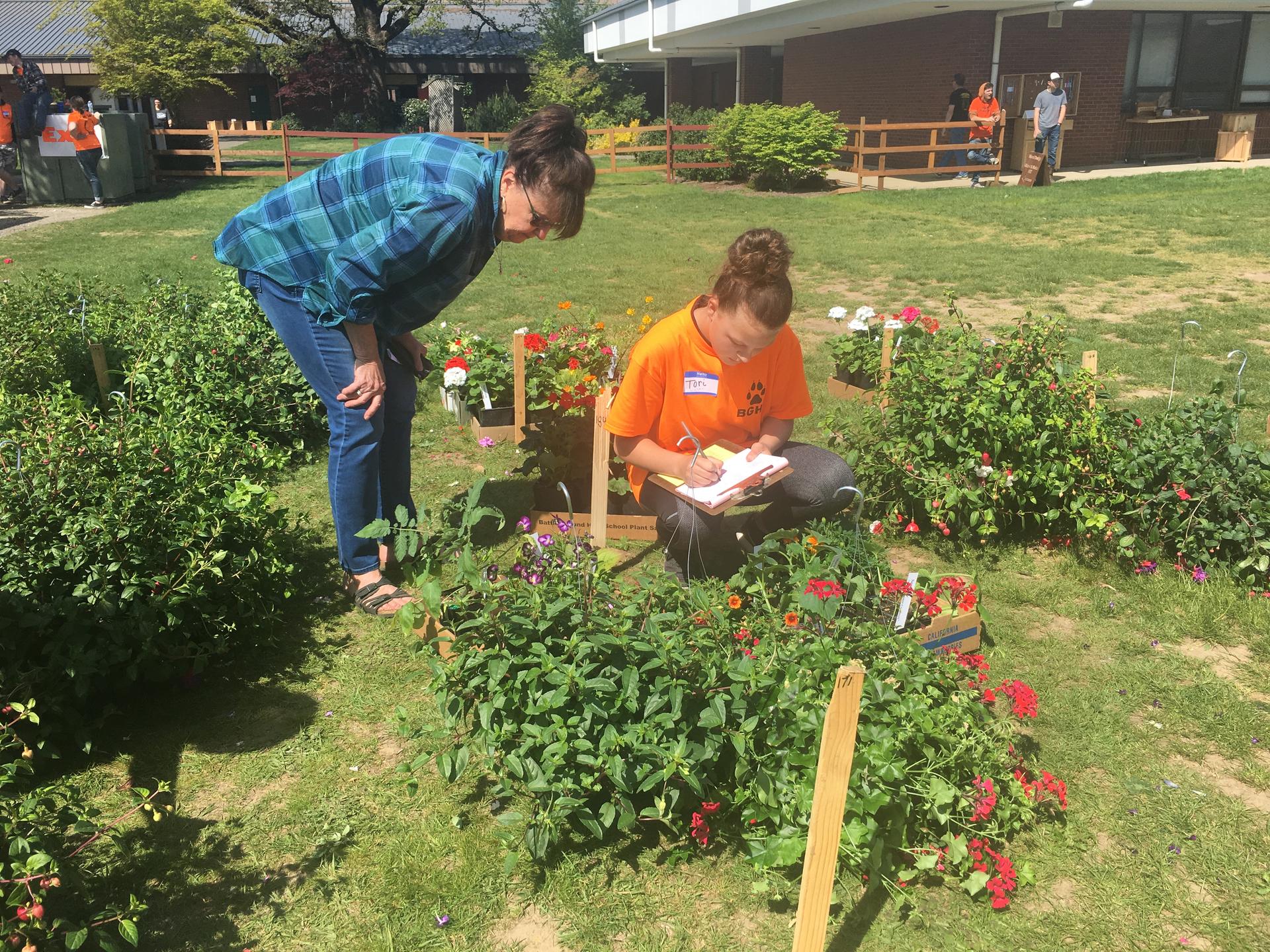 A student checks the inventory at a Battle Ground High School plant sale
