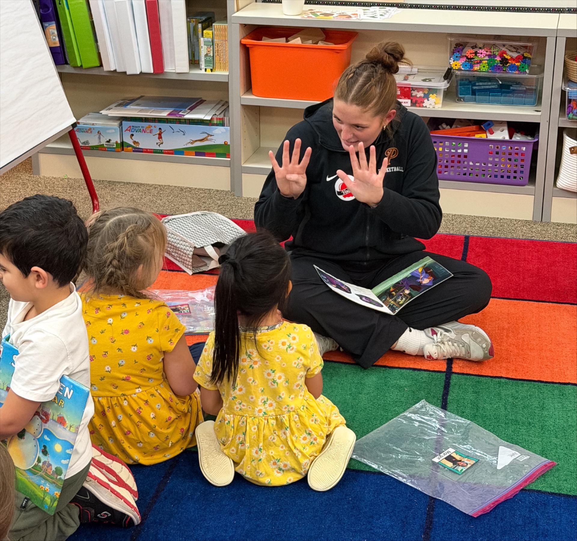 A high schooler counts with two primary school students