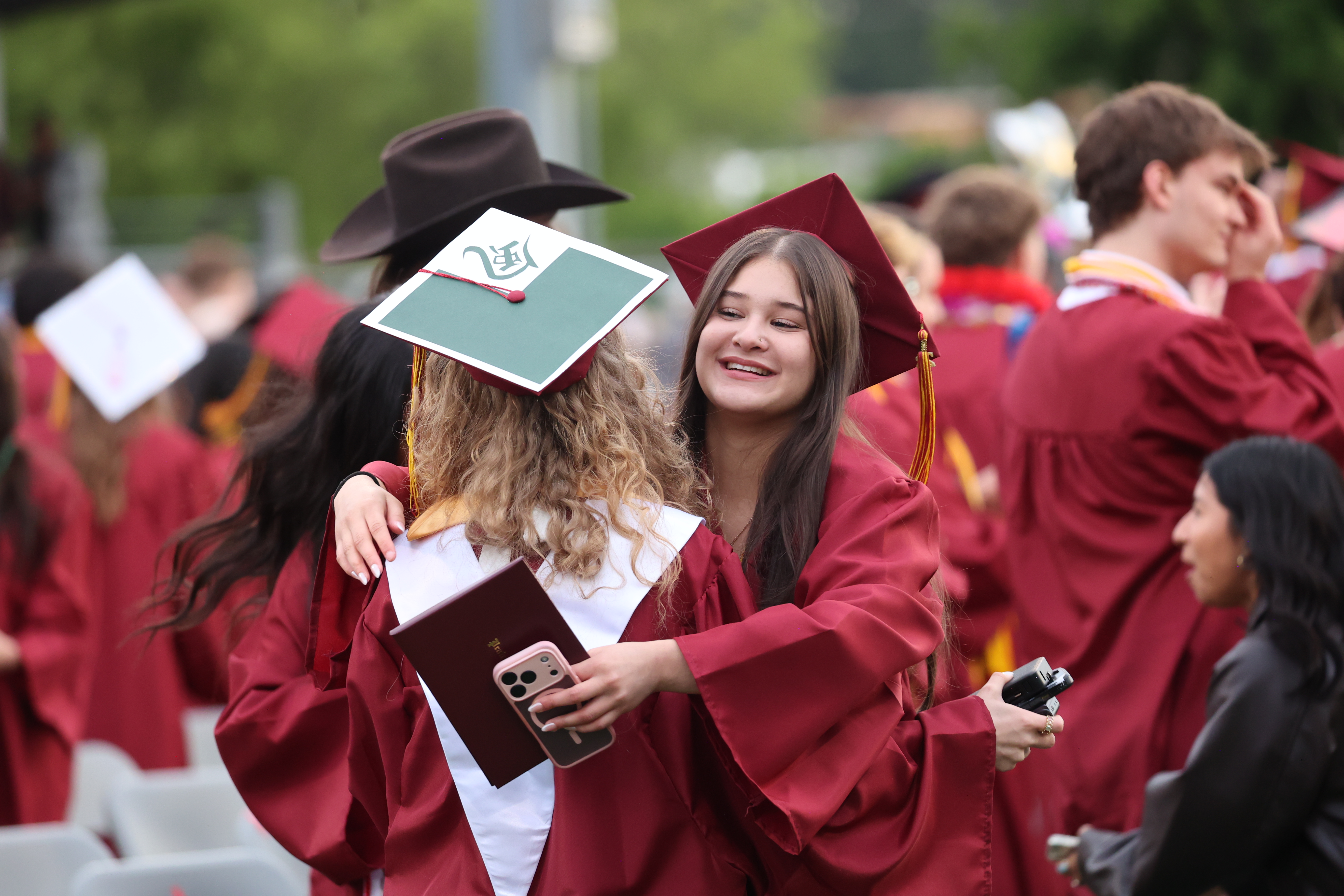 Two Prairie High School graduates embrace at the end of commencement