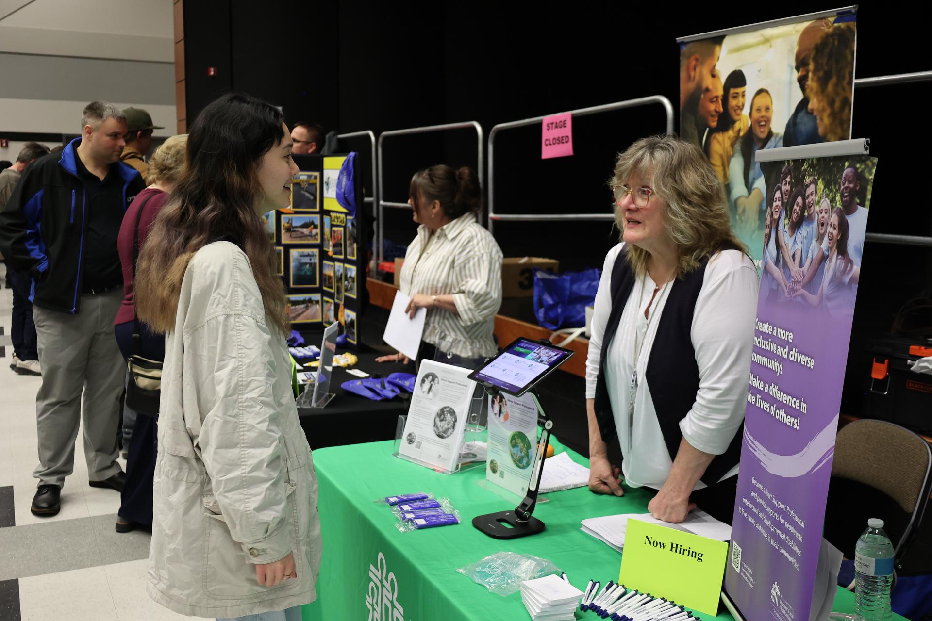 A rep from the Washington State Department of Social and Health Services speak with a fair attendee