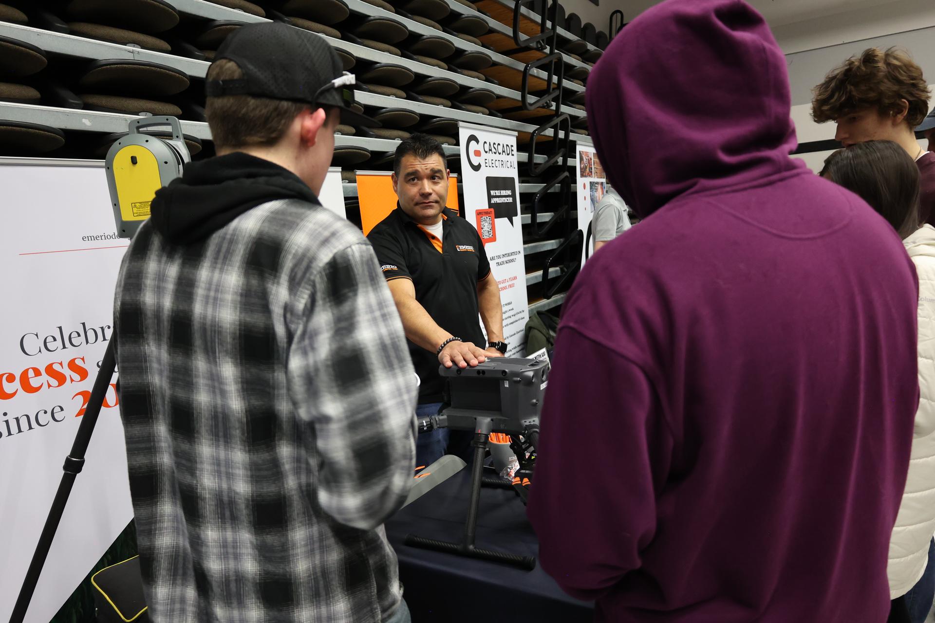 A Cascade Electrical representative speaks to Industry Fair attendees