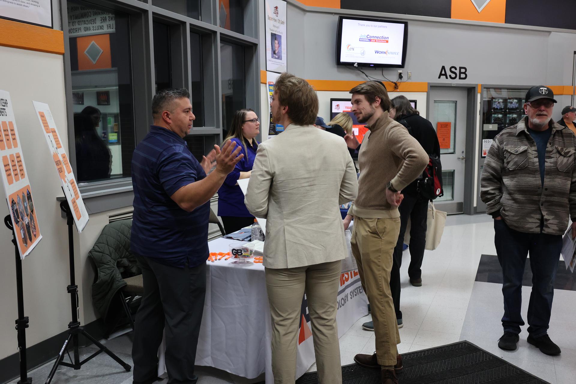 A representative of GB Manchester speaks with attendees
