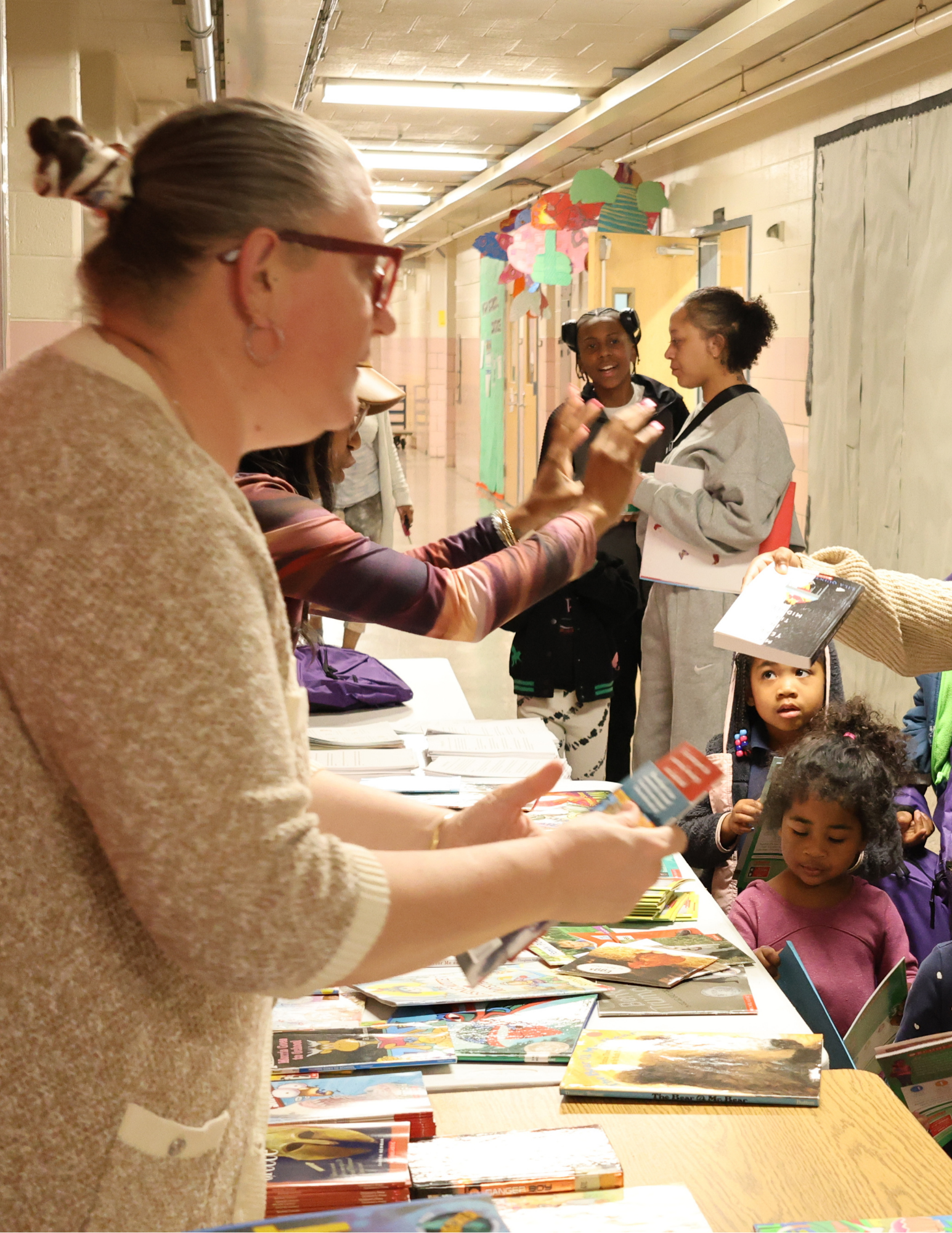 Adult distributing things to students