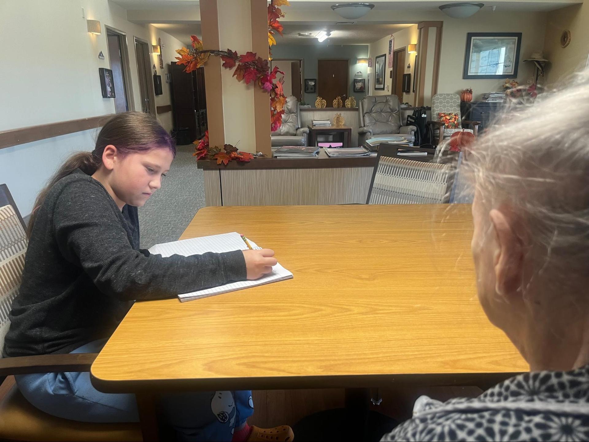 6th graders interviewing residents at the Wallowa Valley Senior Living Center