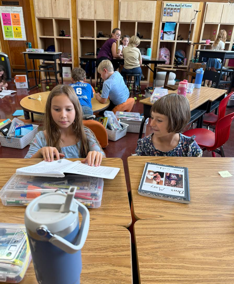 3rd graders reading letters from pen pals