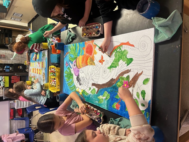 Unit highlights on oversized post-its hang from the classroom walls