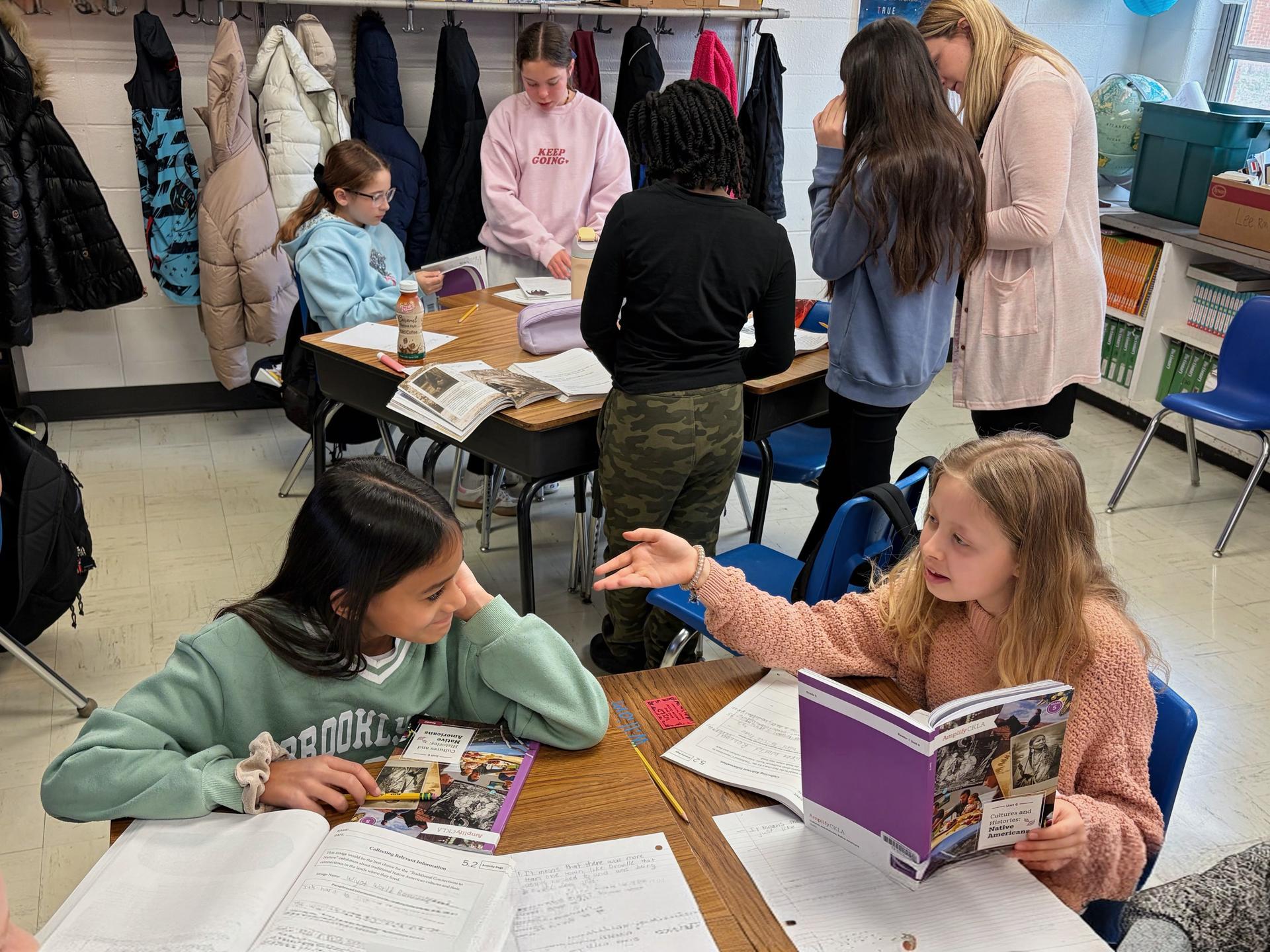 Unit highlights on oversized post-its hang from the classroom walls