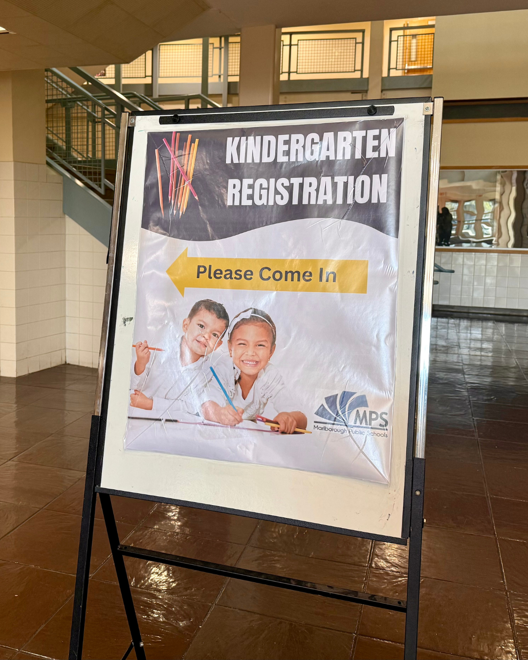 Kindergarten registration poster on an easel.