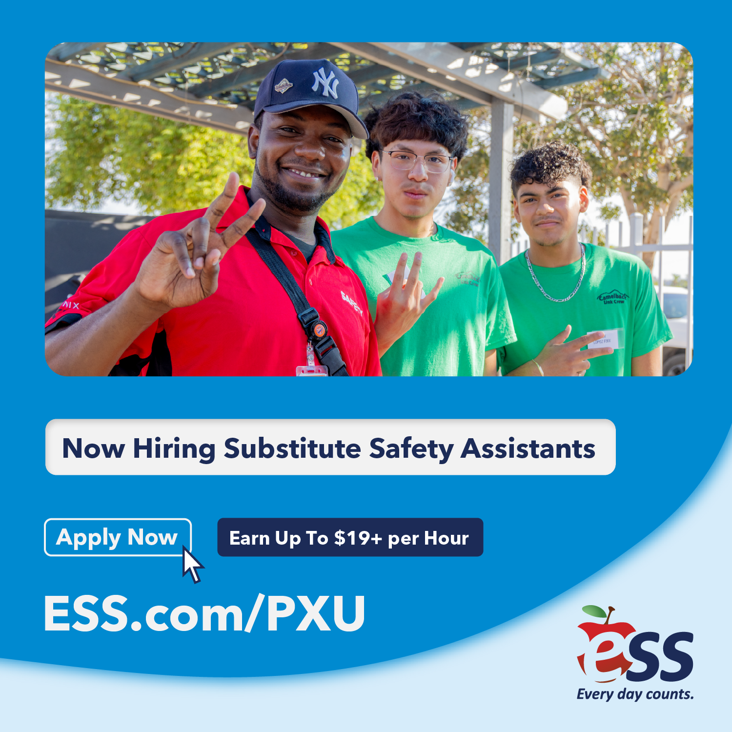 Three individuals, two wearing green shirts, one in red, pose for a hiring advertisement. The background includes a metal structure and trees.
