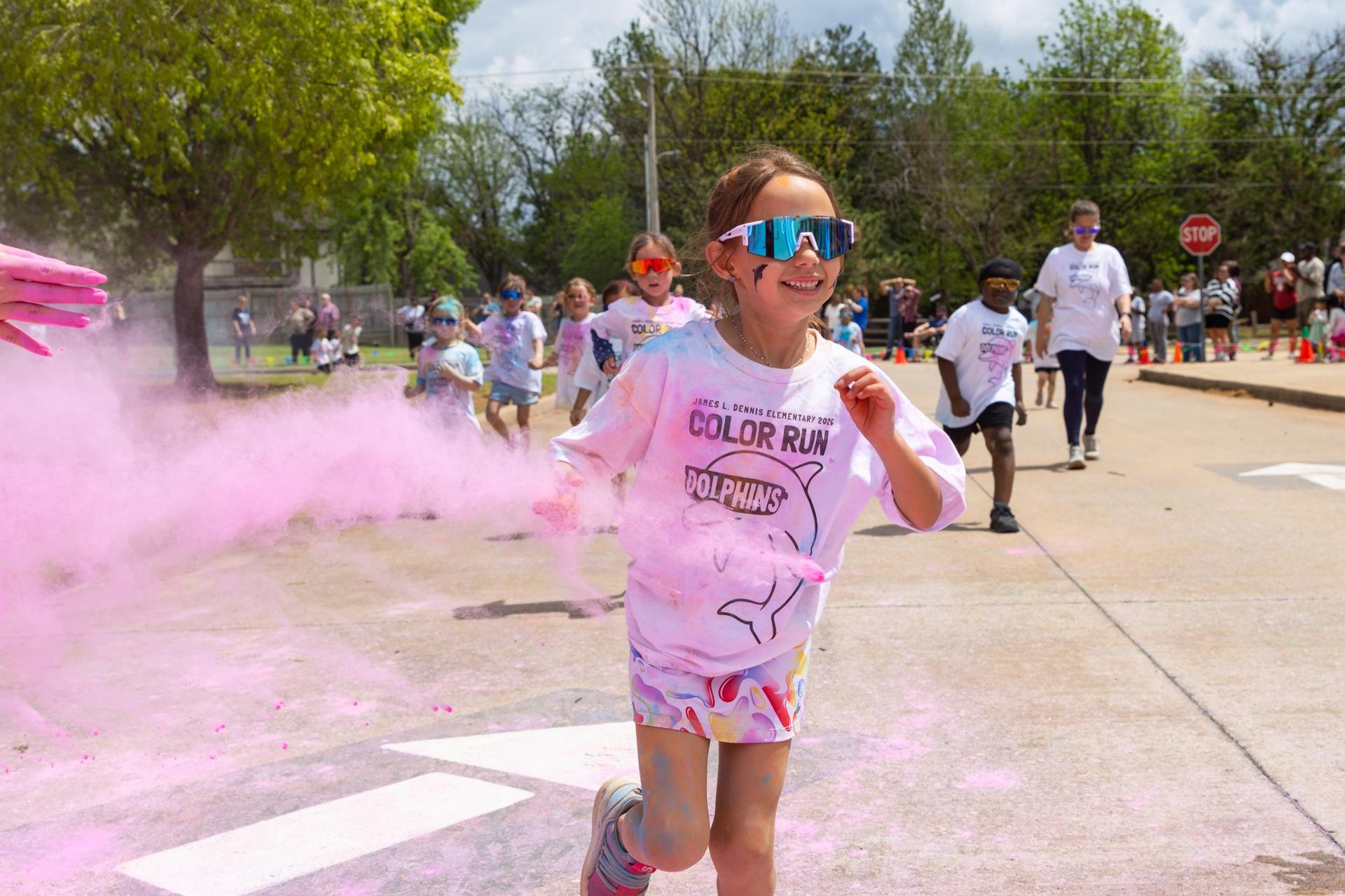 pink chalk being tossed on student