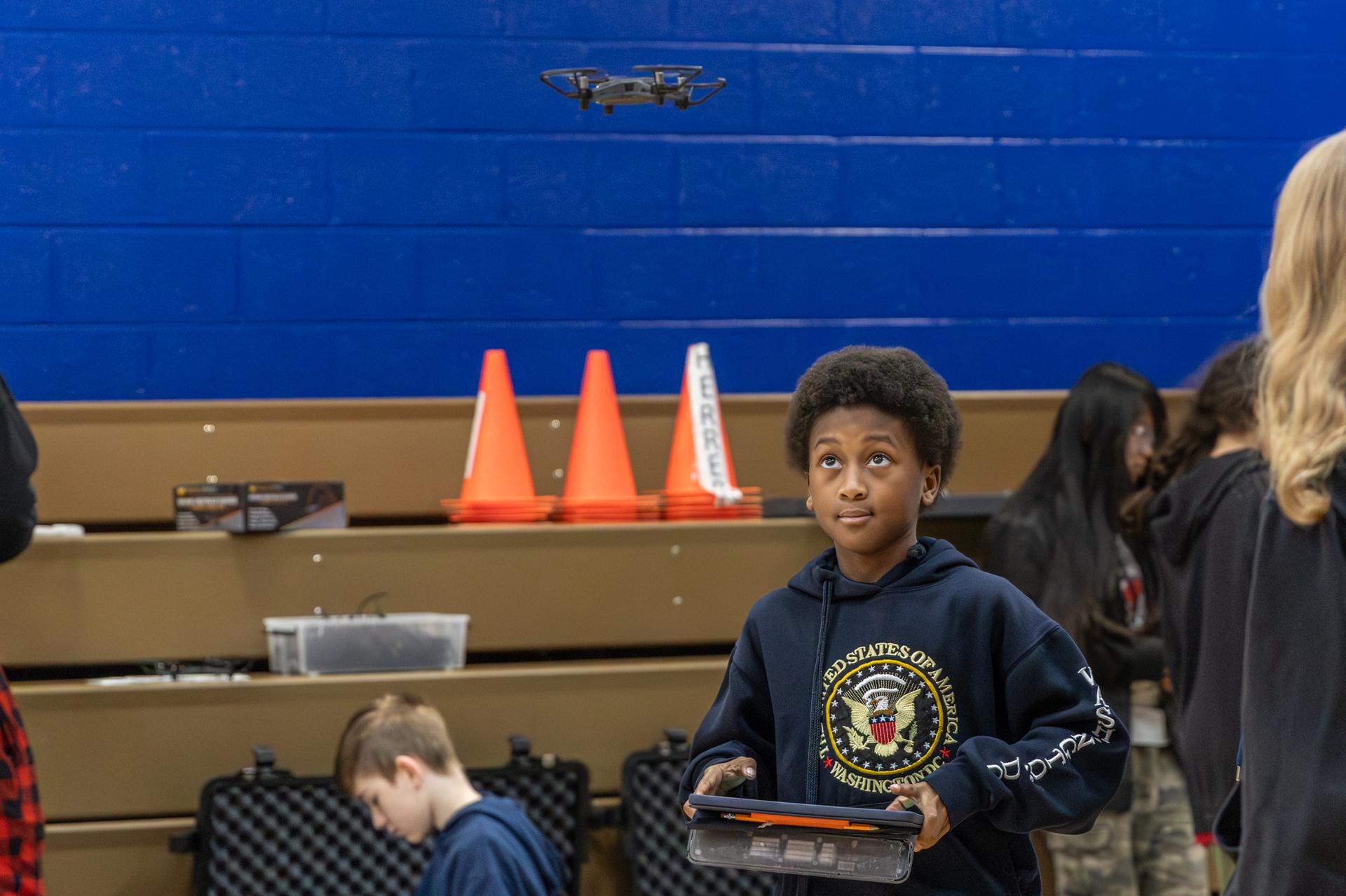 student looking and playing with drone