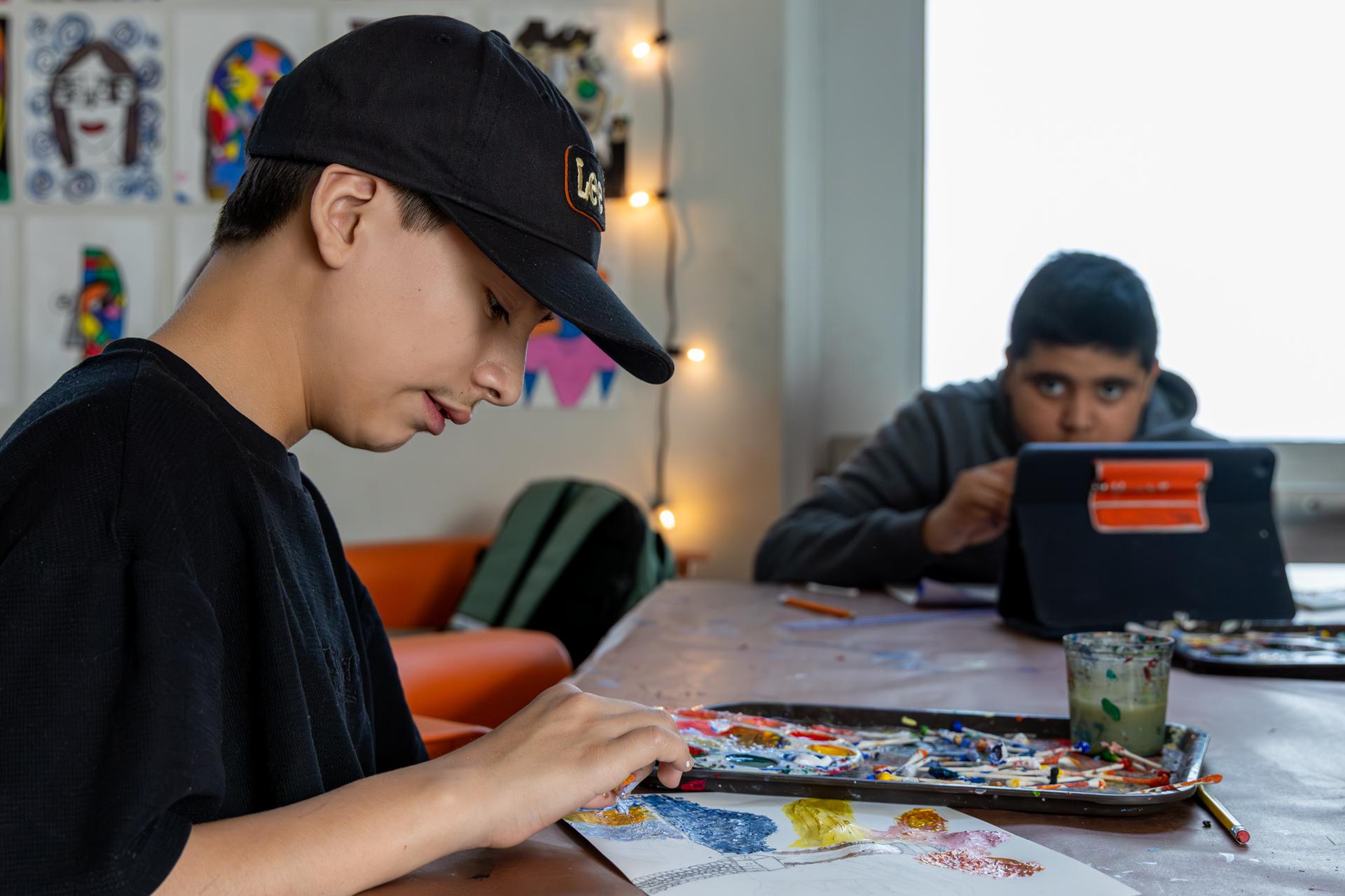 1 student painting using a q-tip