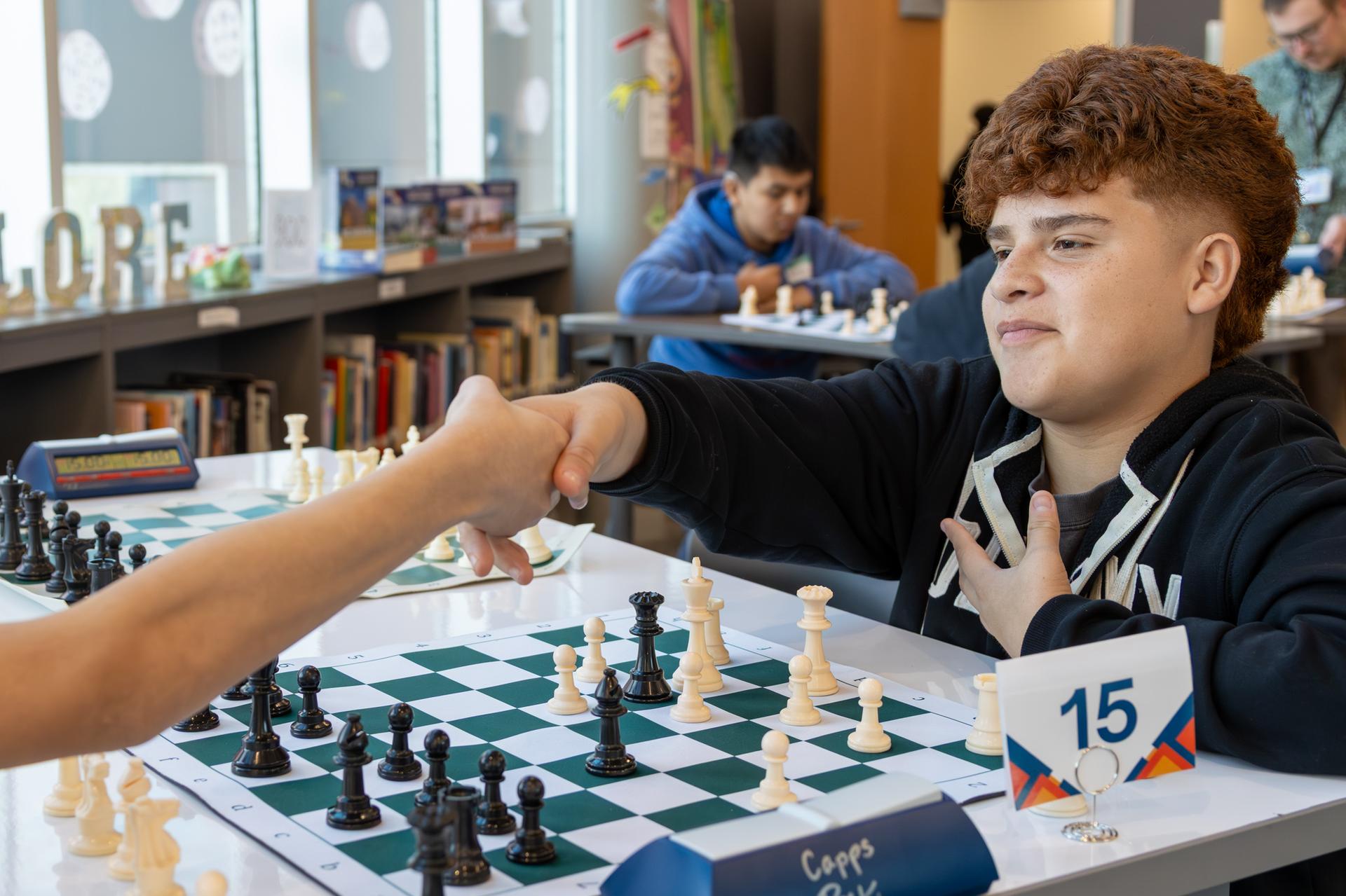 student shaking hands with their opponent 