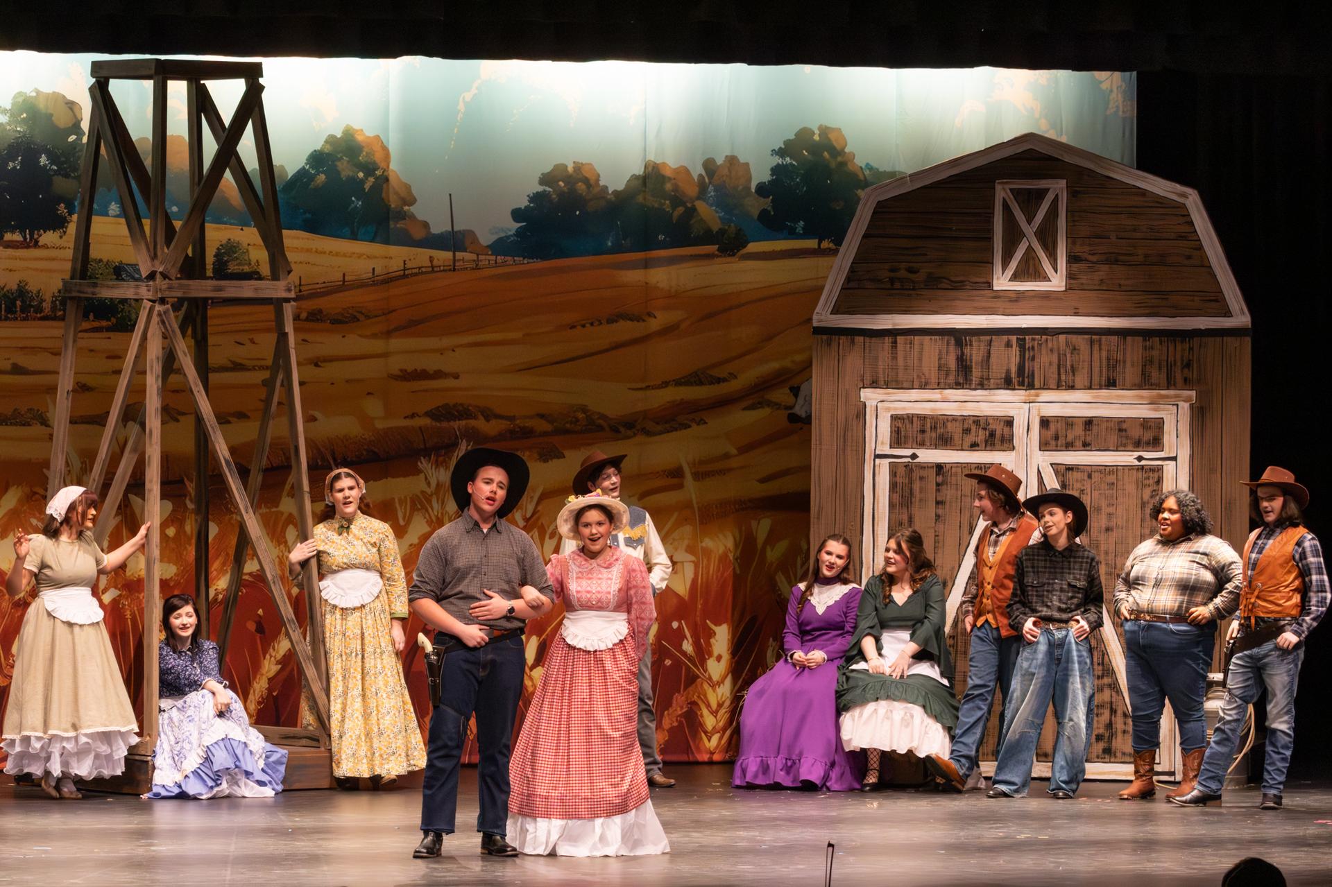 group image of cast looking into the audience