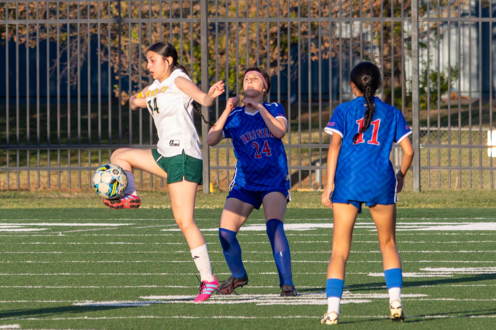 western oak female athlete kicking the ball