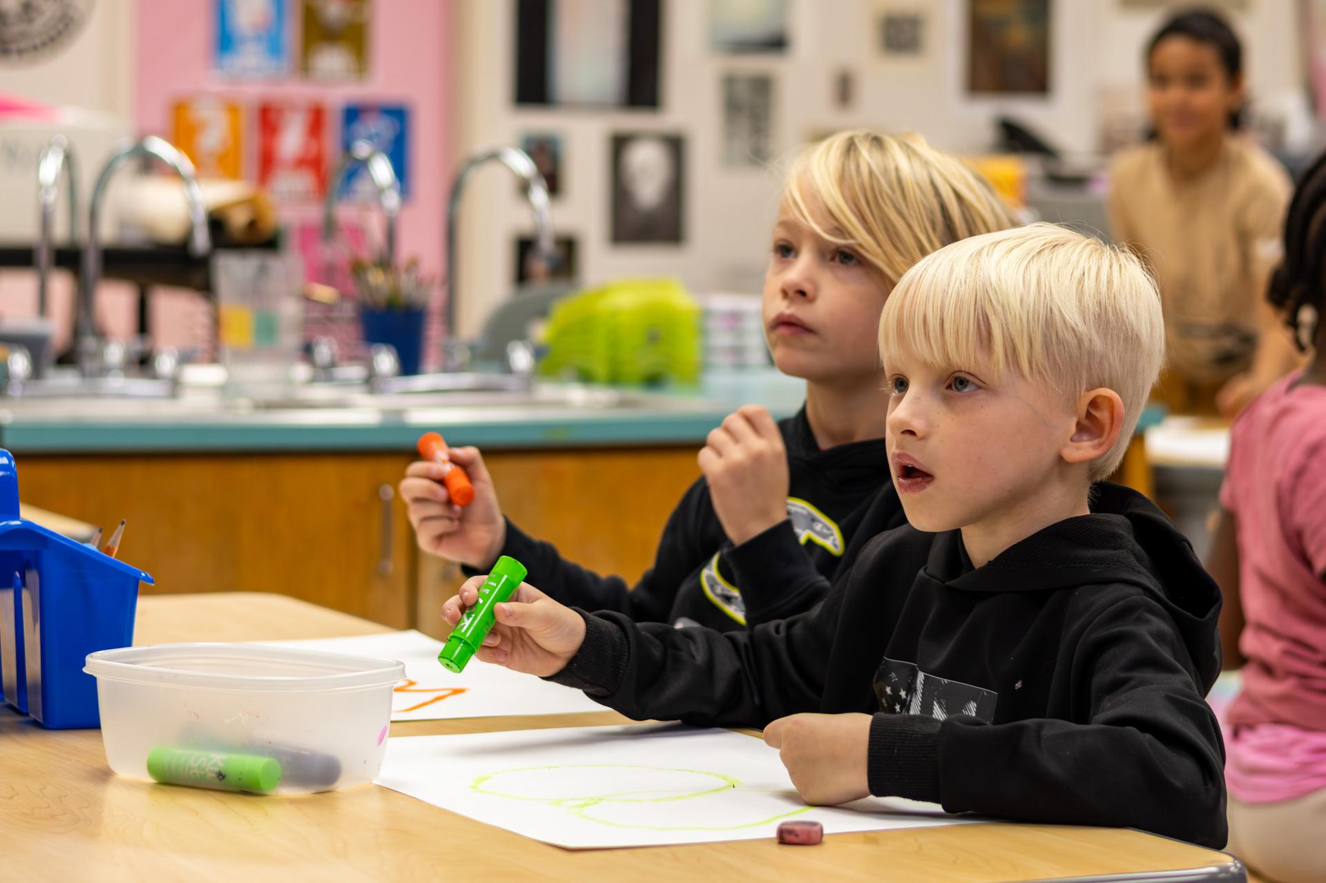 2nd grader doing art in classroom