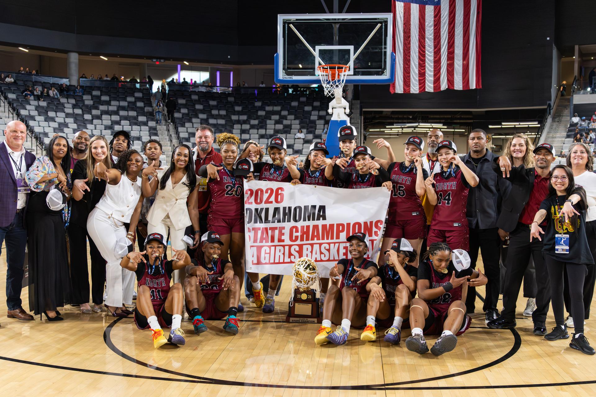 Group photo of the PCN girls holding the state champions banner with trophy