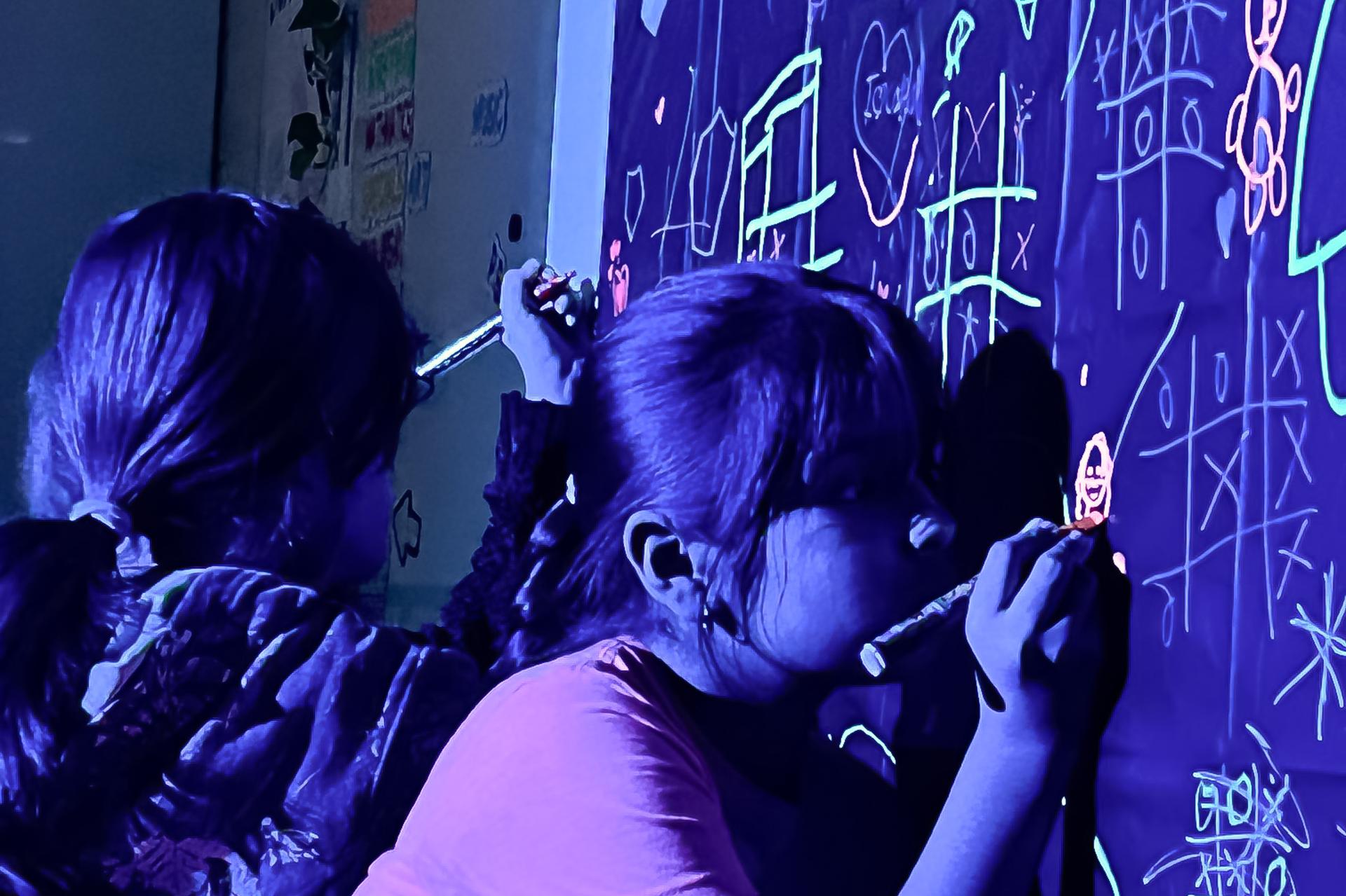 students playing games on chalkboard