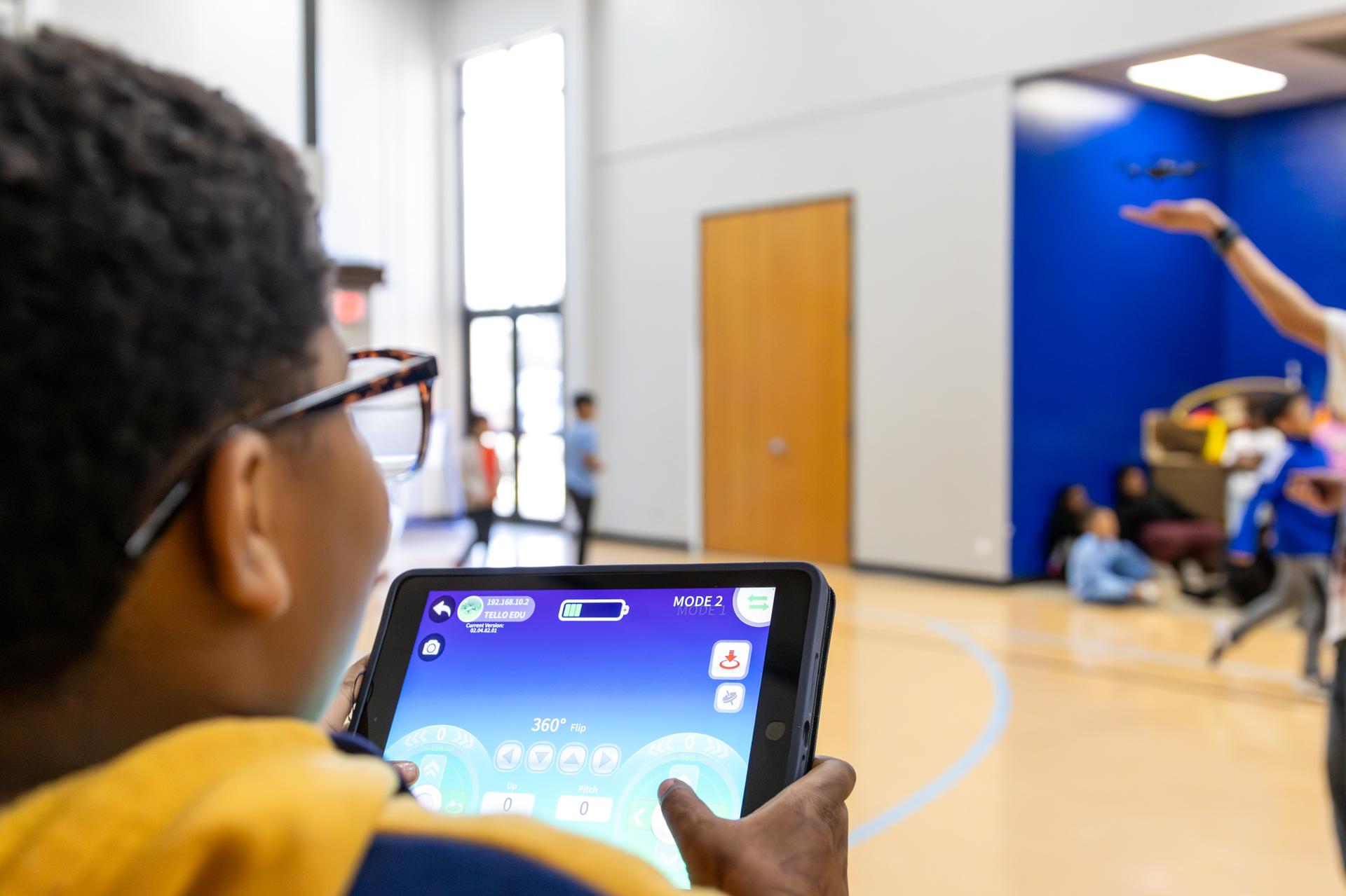 student on tablet learning about the drone