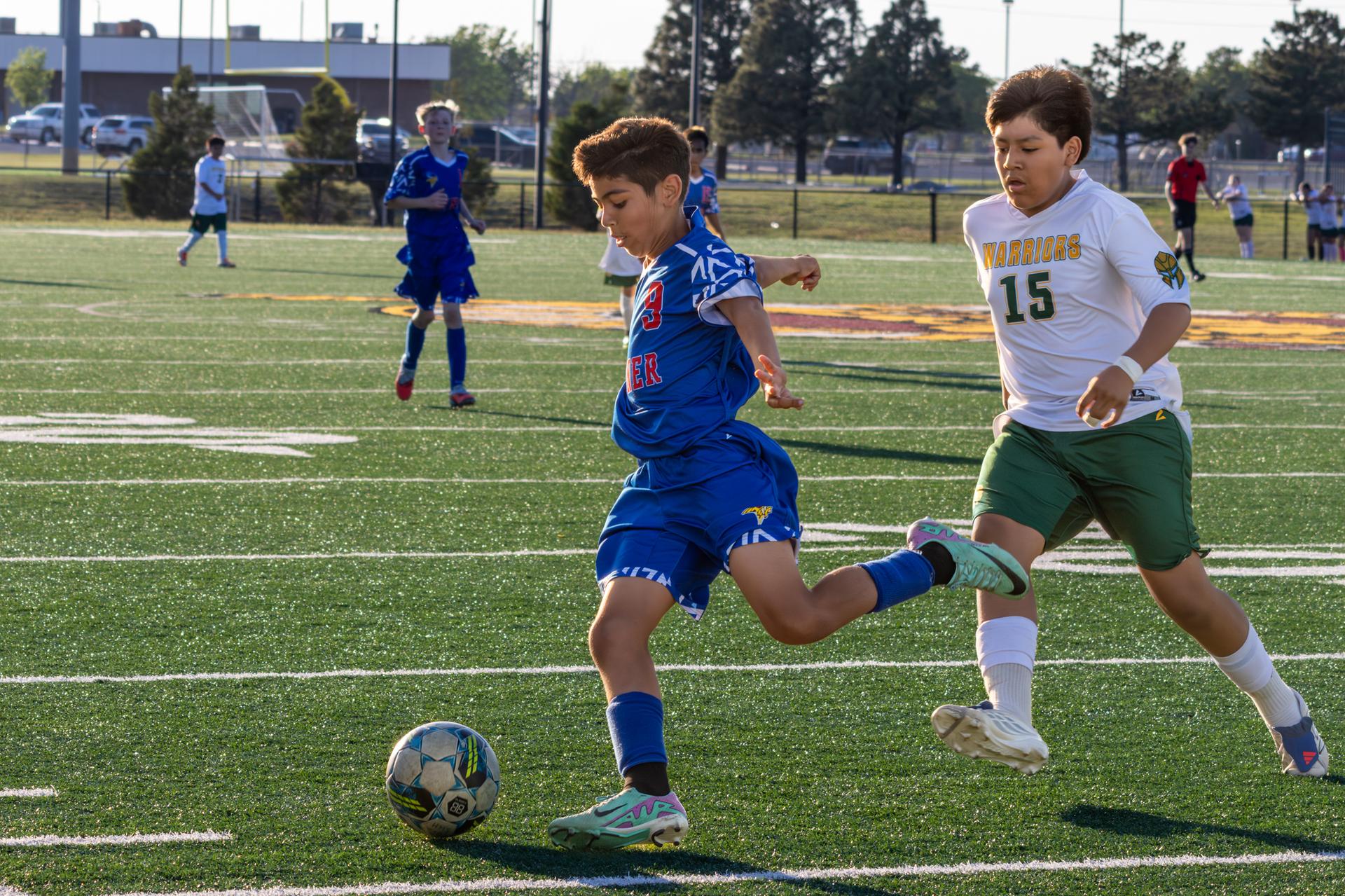 hefner student going in for a big kick on the ball
