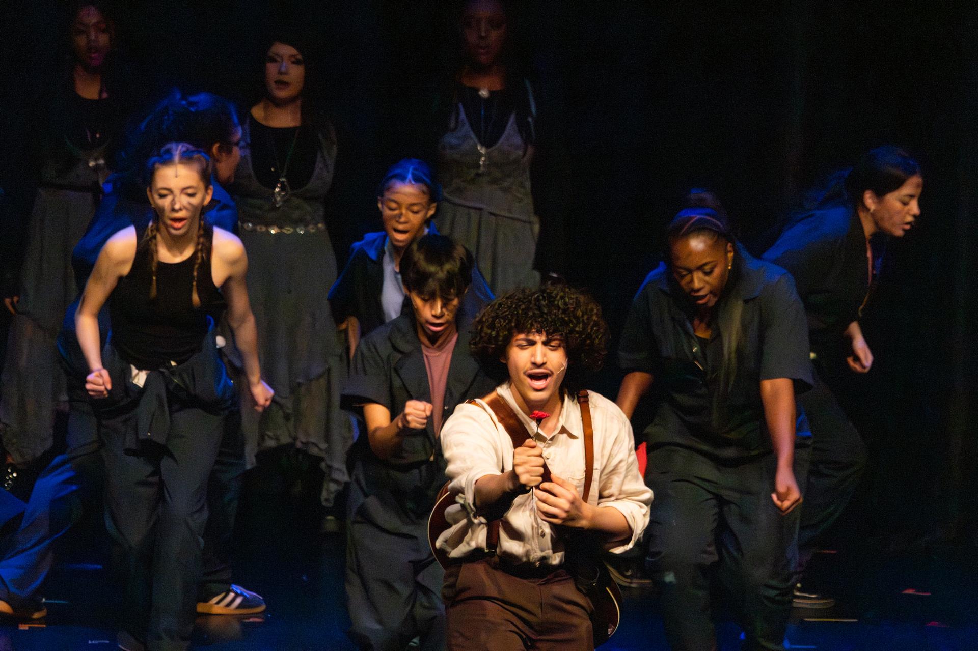 main character of play holding a rose