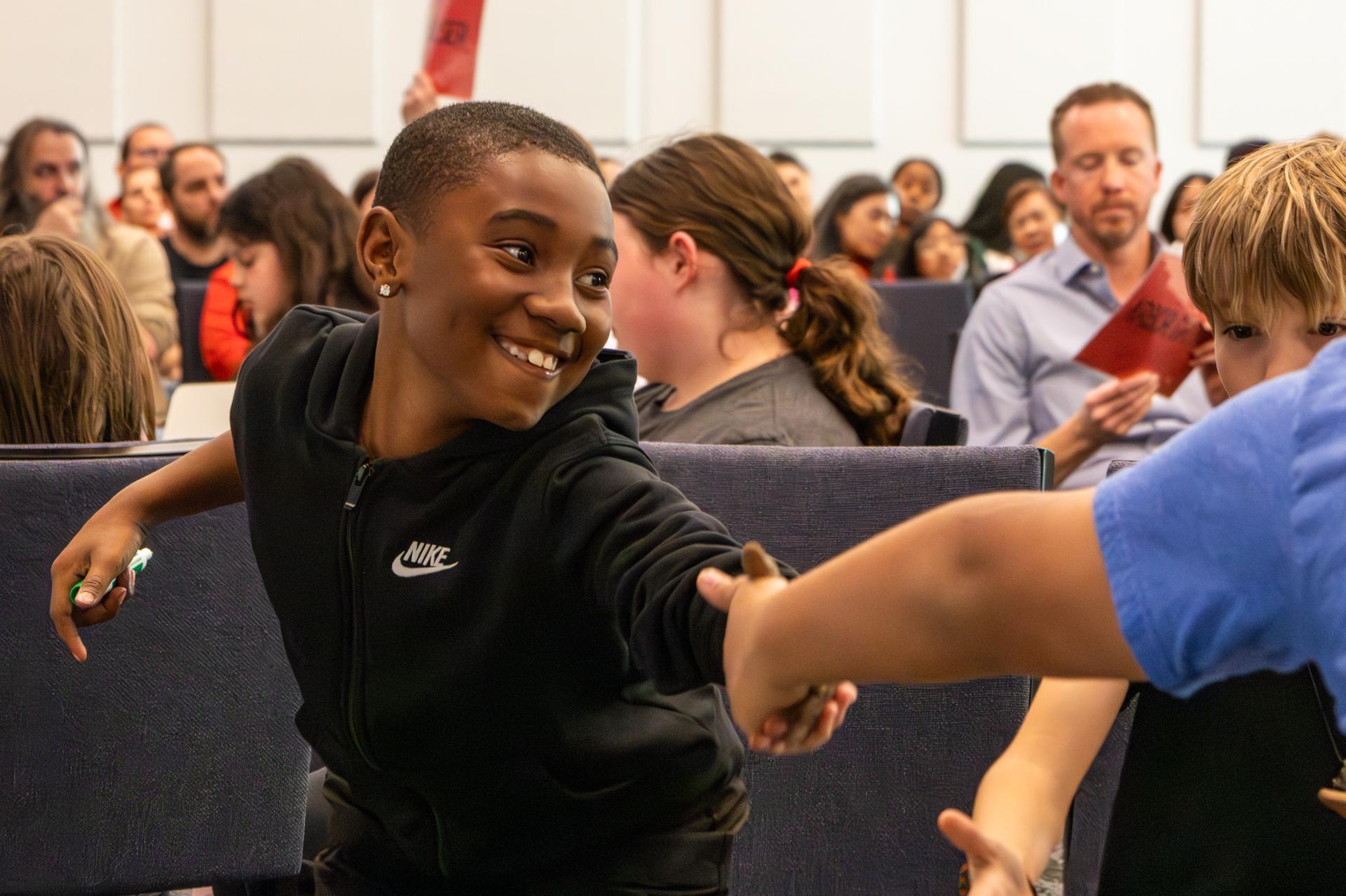 student giving a hand shake