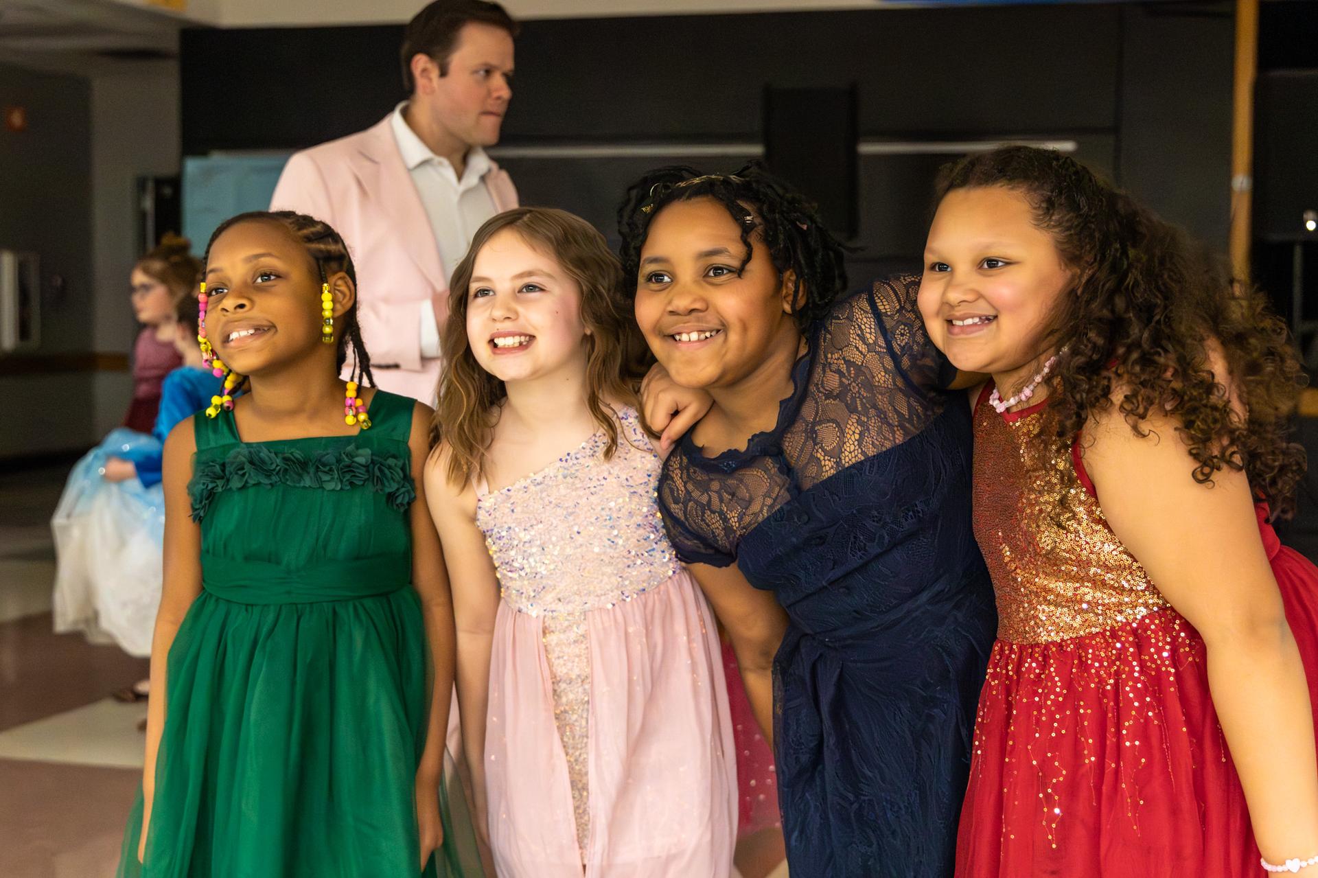 elementary students smiling and dolled up for ball