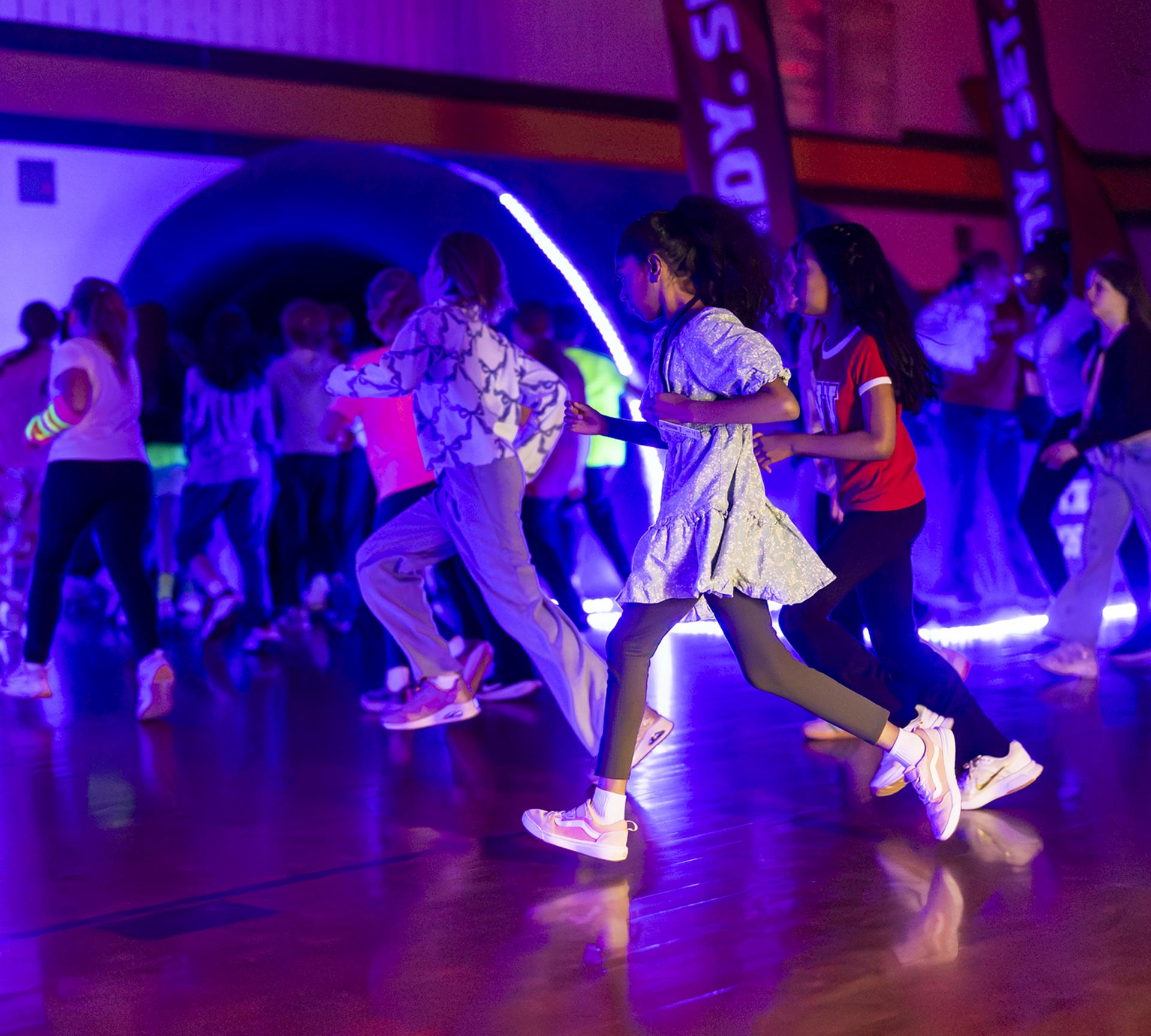 Students running during the Glow Run