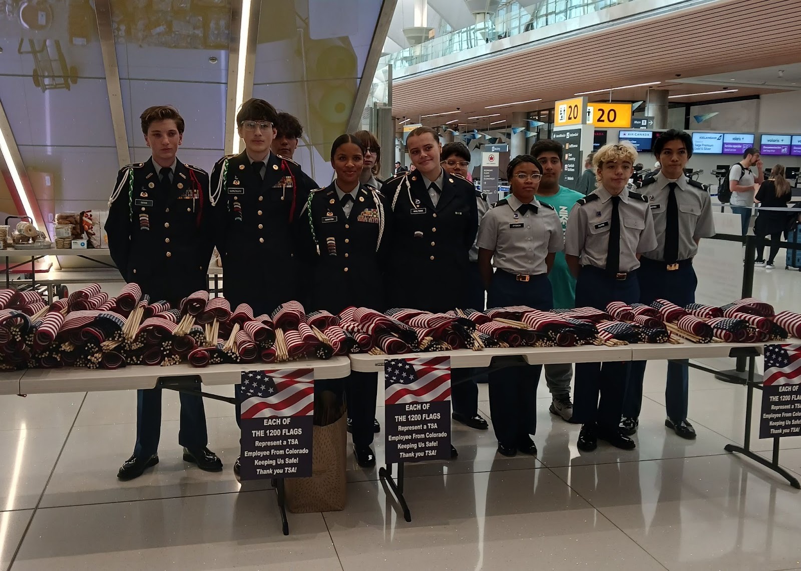 JROTC cadets passing out US flags at DEN