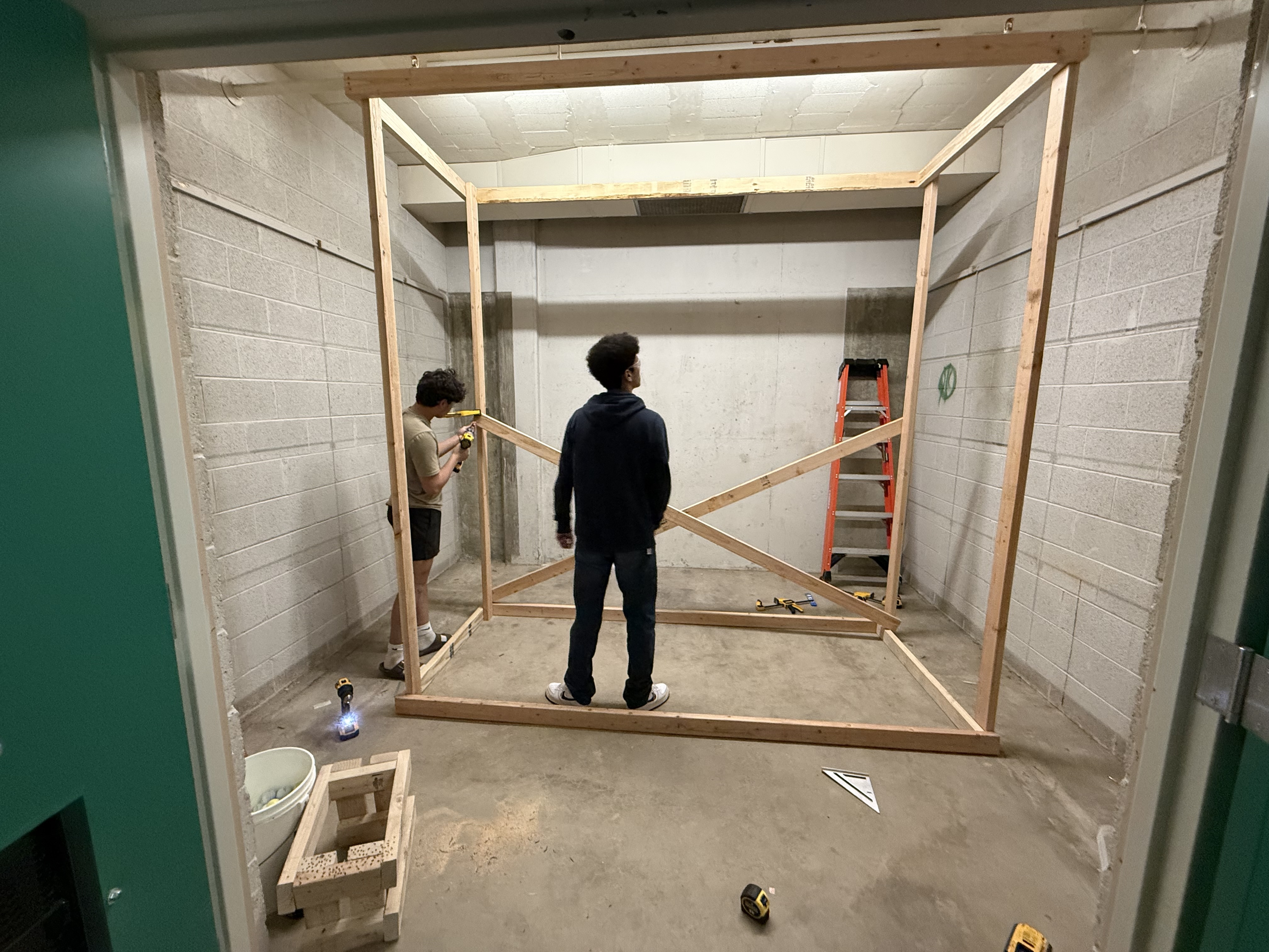 Students work on building a wall