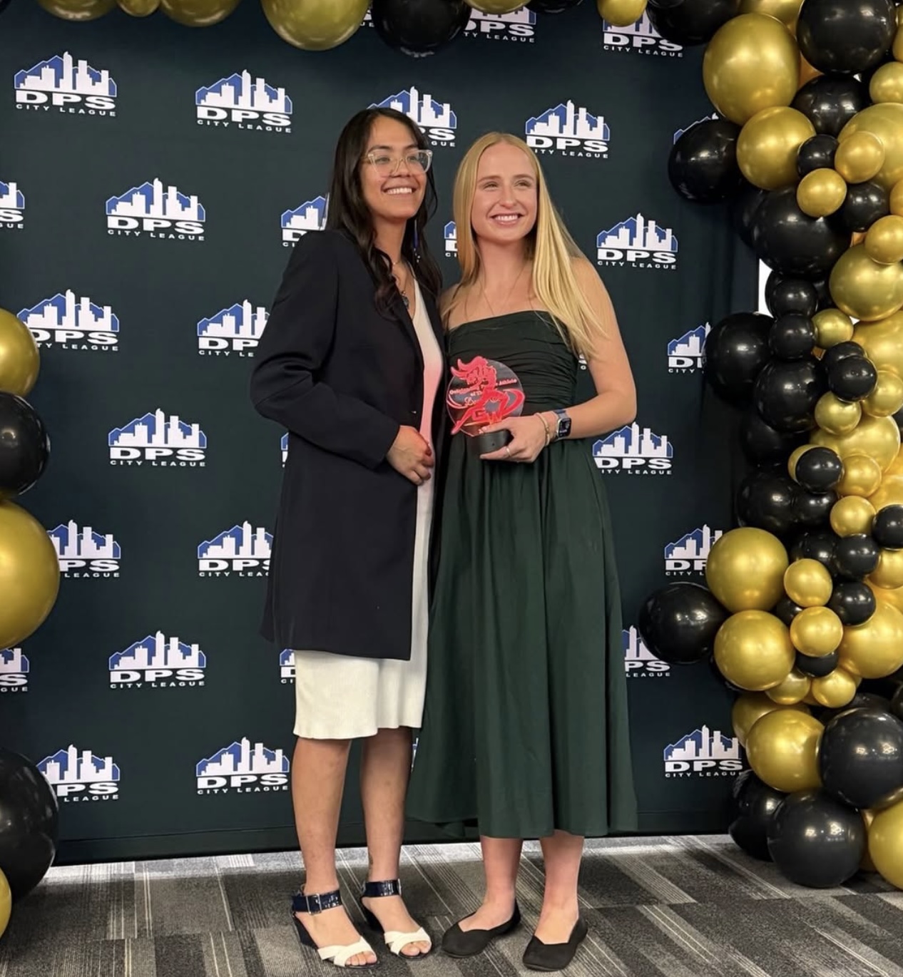 Student accepting award for DPS Athlete of the Year