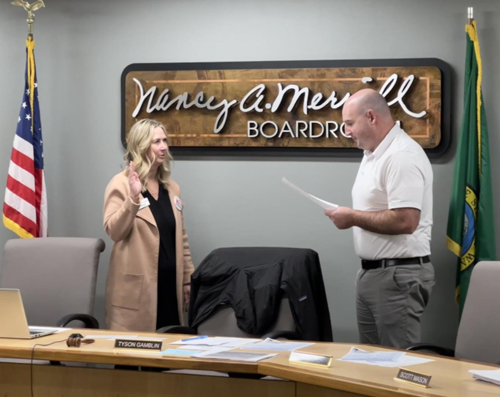 Interim Superintendent, Jill Burnes repeating her oath of office to Director Gamblin at a board meeting