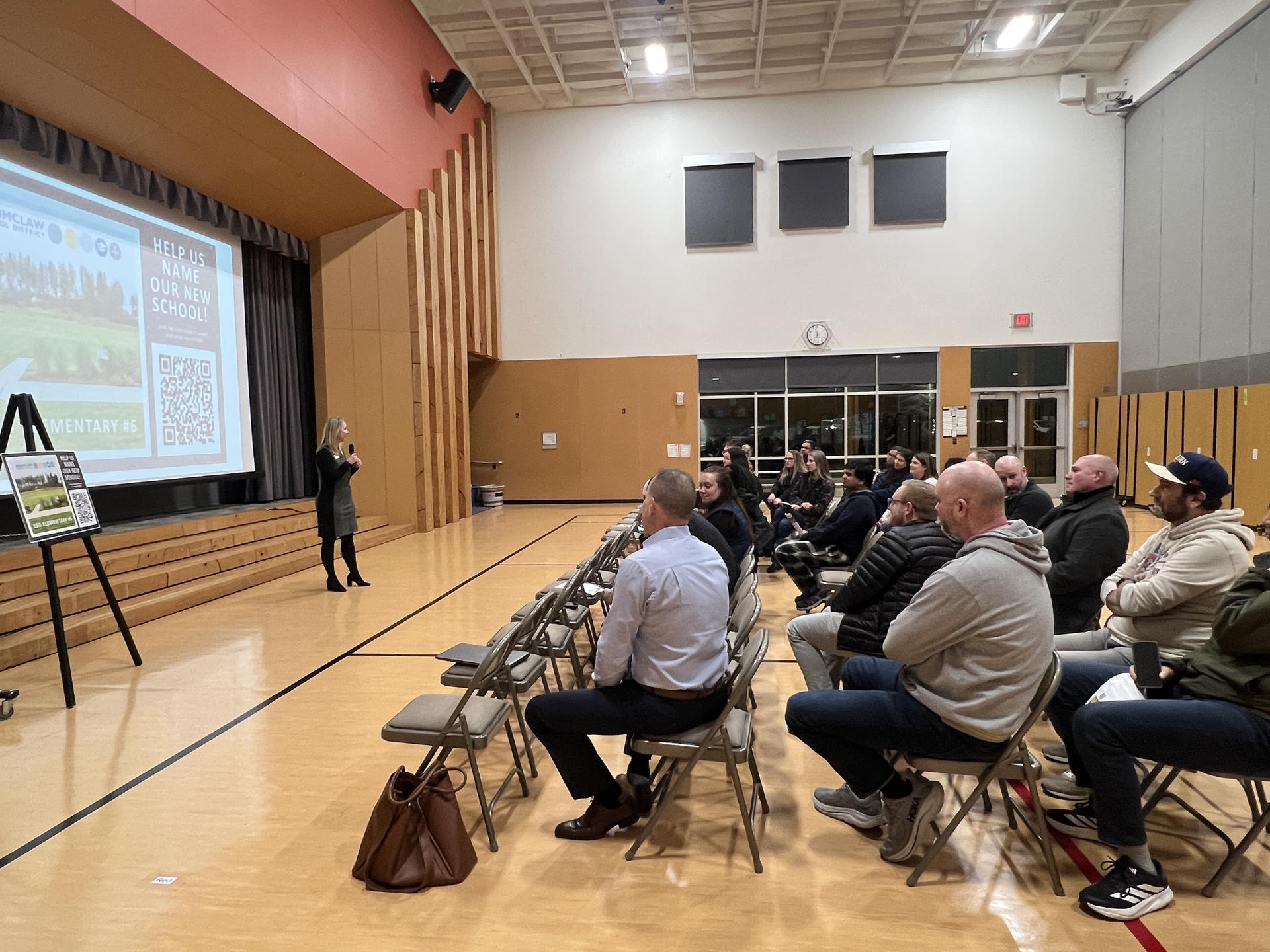 Superintendent Burnes standing in front of an audience at BDE resenting to Ten Trails families and community regarding ESD Elementary #6 at BED